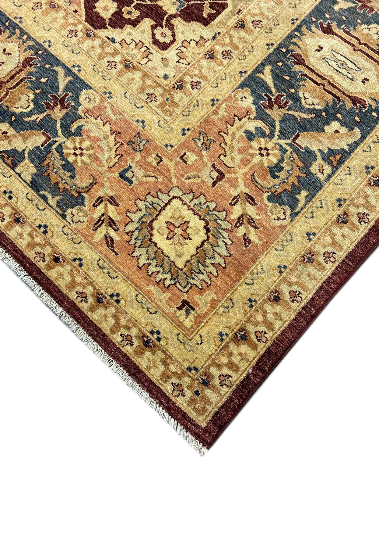 Detailed close-up of a 12' x 15' Agra rug corner, showcasing the intricate classical motifs and the high-quality natural wool texture. The vibrant vegetable-dyed colors highlight the craftsmanship of the handwoven rug.