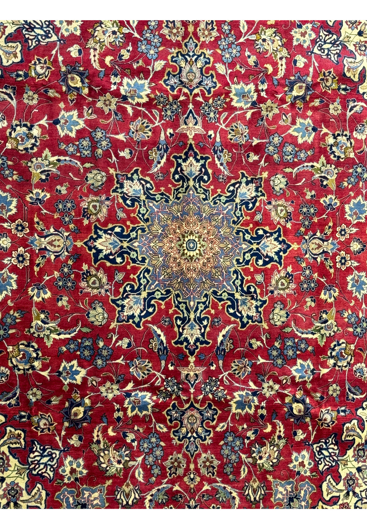 Close-up of the central medallion on a Persian Isfahan rug, featuring blue and gold intricate patterns