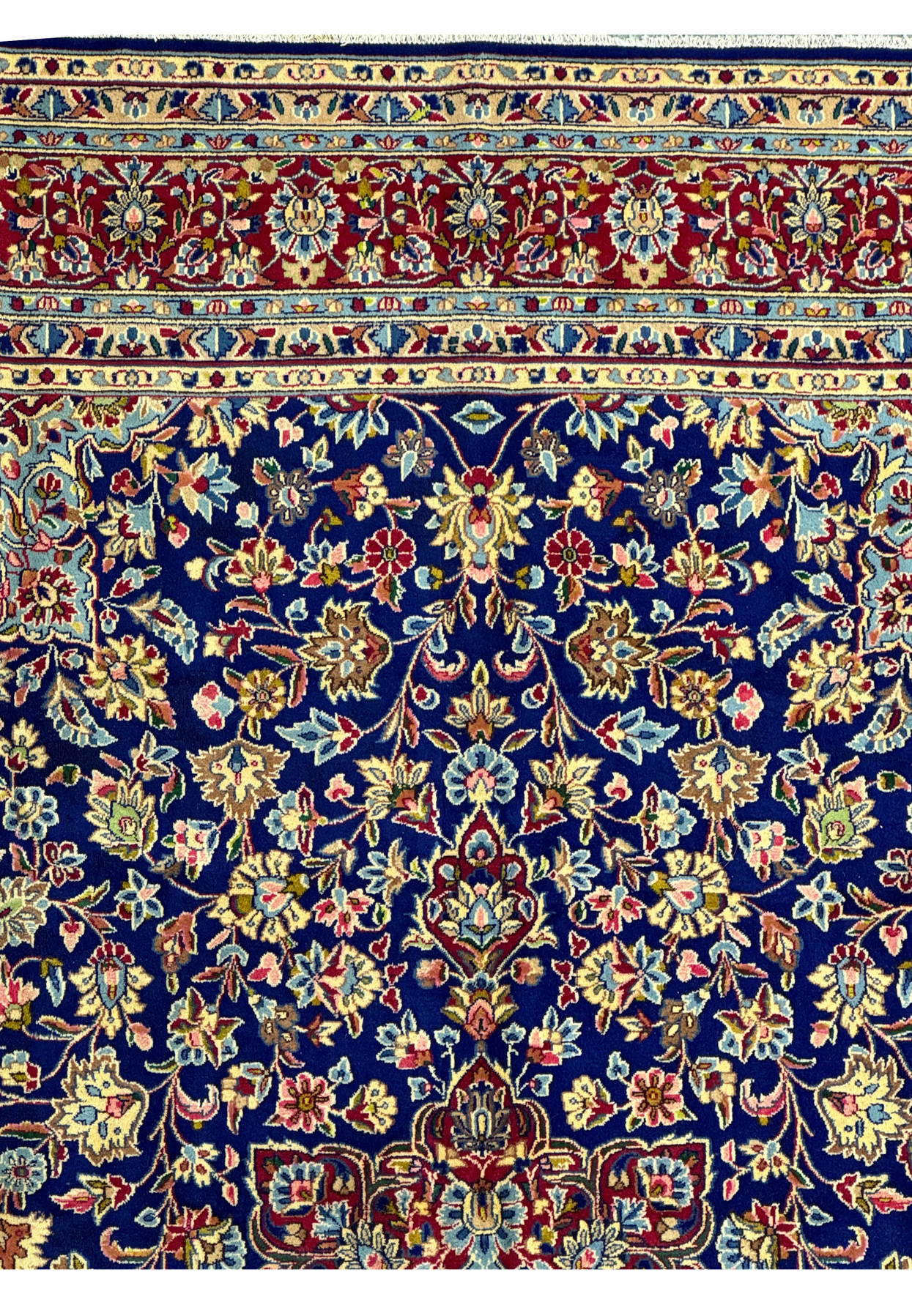 Detailed shot of the upper left corner of a Persian Kerman Rug, showcasing the intricate floral patterns and the quality of the weaving.