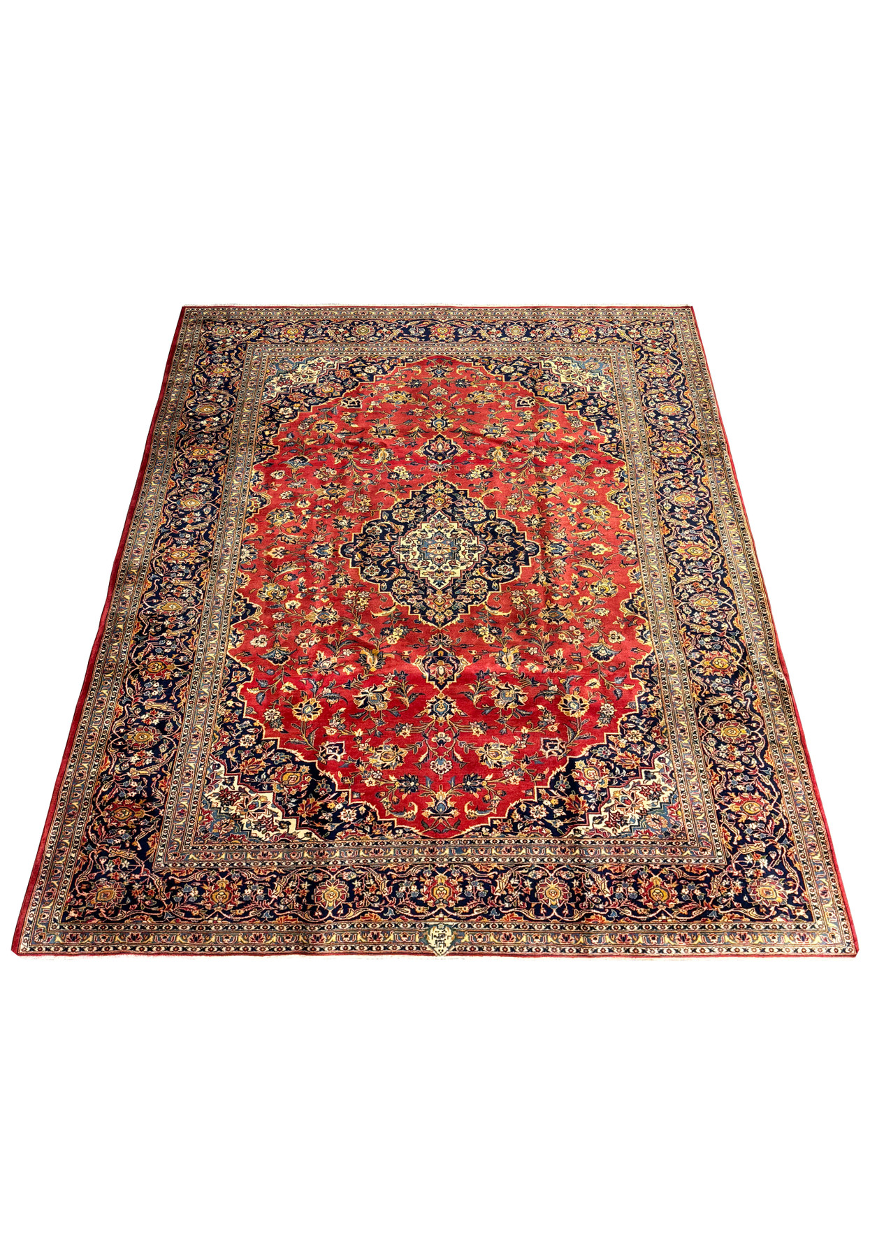 Full view of a Persian Kashan rug, measuring 9'2" x 12'5". The rug is laid out flat, revealing its detailed floral and medallion design against a striking red background. The intricate border frames the central pattern, with harmonious colors of blue, gold, and ivory enhancing its visual appeal. The high-quality materials and craftsmanship are evident, making this rug a perfect centerpiece for any sophisticated living space.