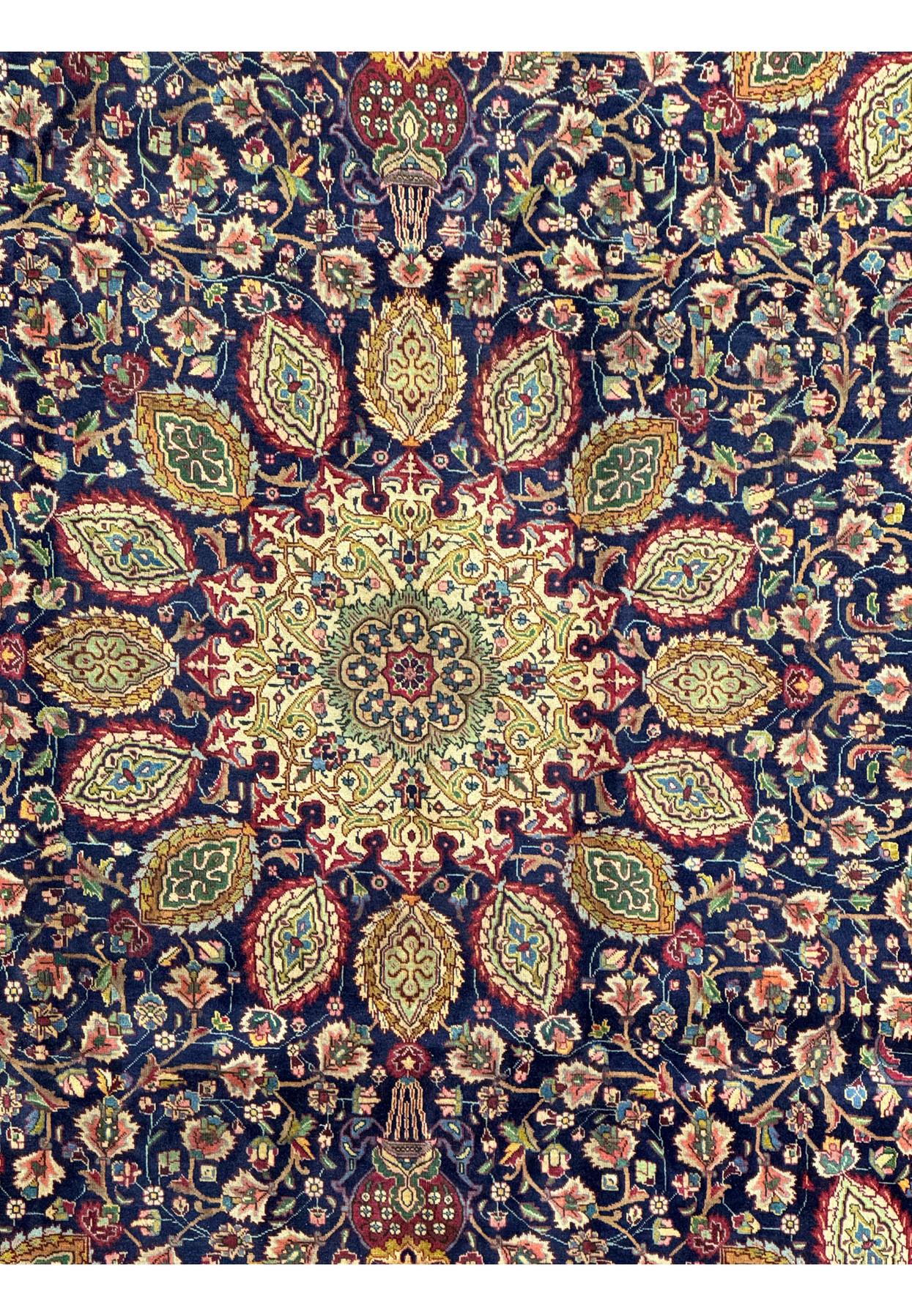 Detailed section of the Persian Tabriz Rug, focusing on the upper central part. The image reveals the precise and elaborate design, with floral and leaf motifs intricately woven in rich hues of red, green, and gold. The craftsmanship is evident in the fine detailing and harmonious color palette, which enhances the overall aesthetic of the rug.