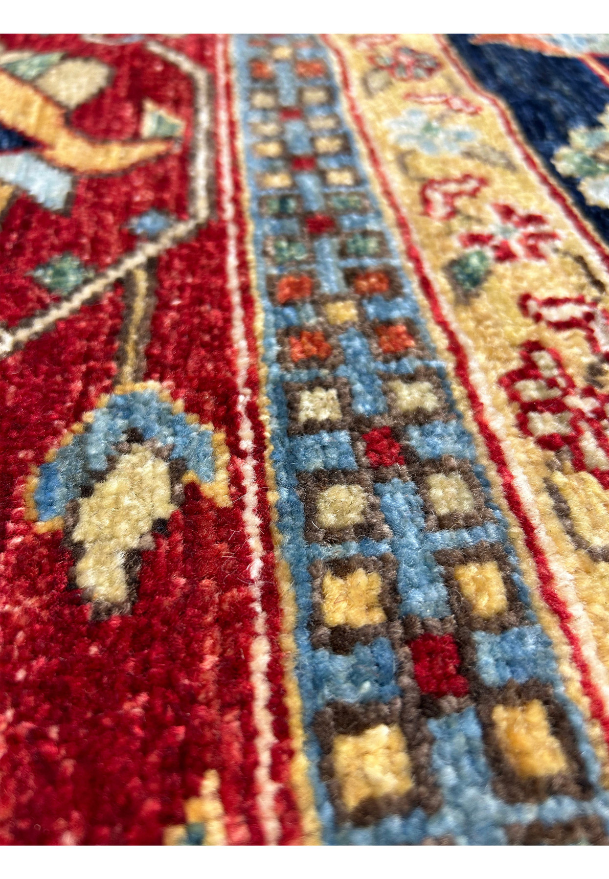 Side view of a 10x16'4 Ziegler rug, emphasizing the deep red border with intricate floral designs.