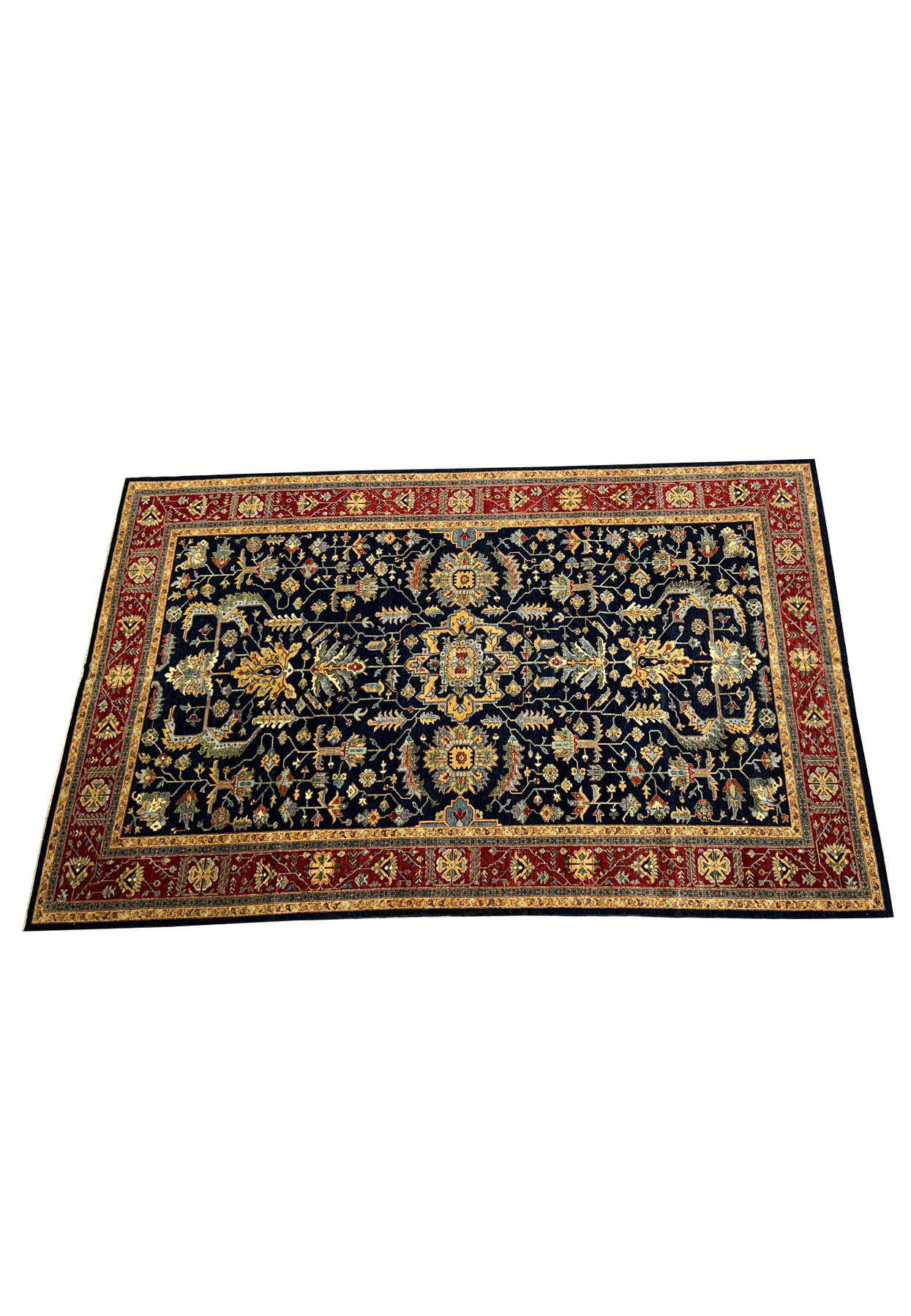 Angled view of a 10x16 handmade Ziegler rug, highlighting the rich navy blue field adorned with traditional Soultanabad design elements.