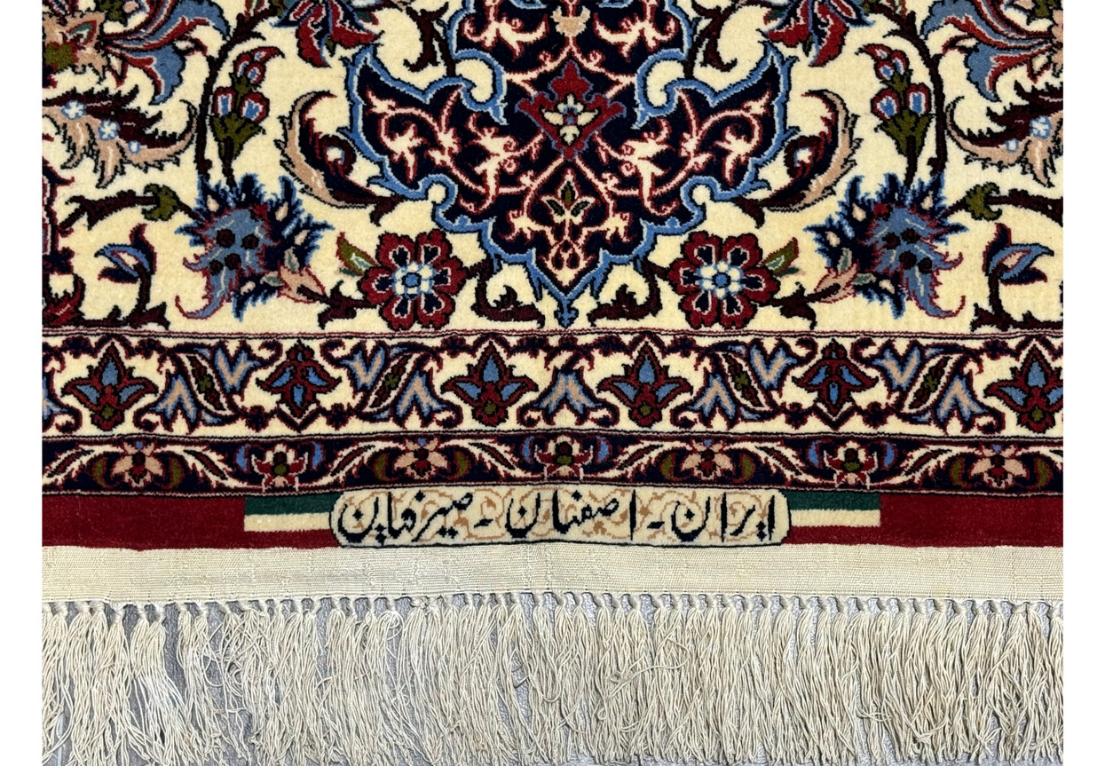 Signature of Seirafian on Persian Isfahan Silk Rug with detailed border design.