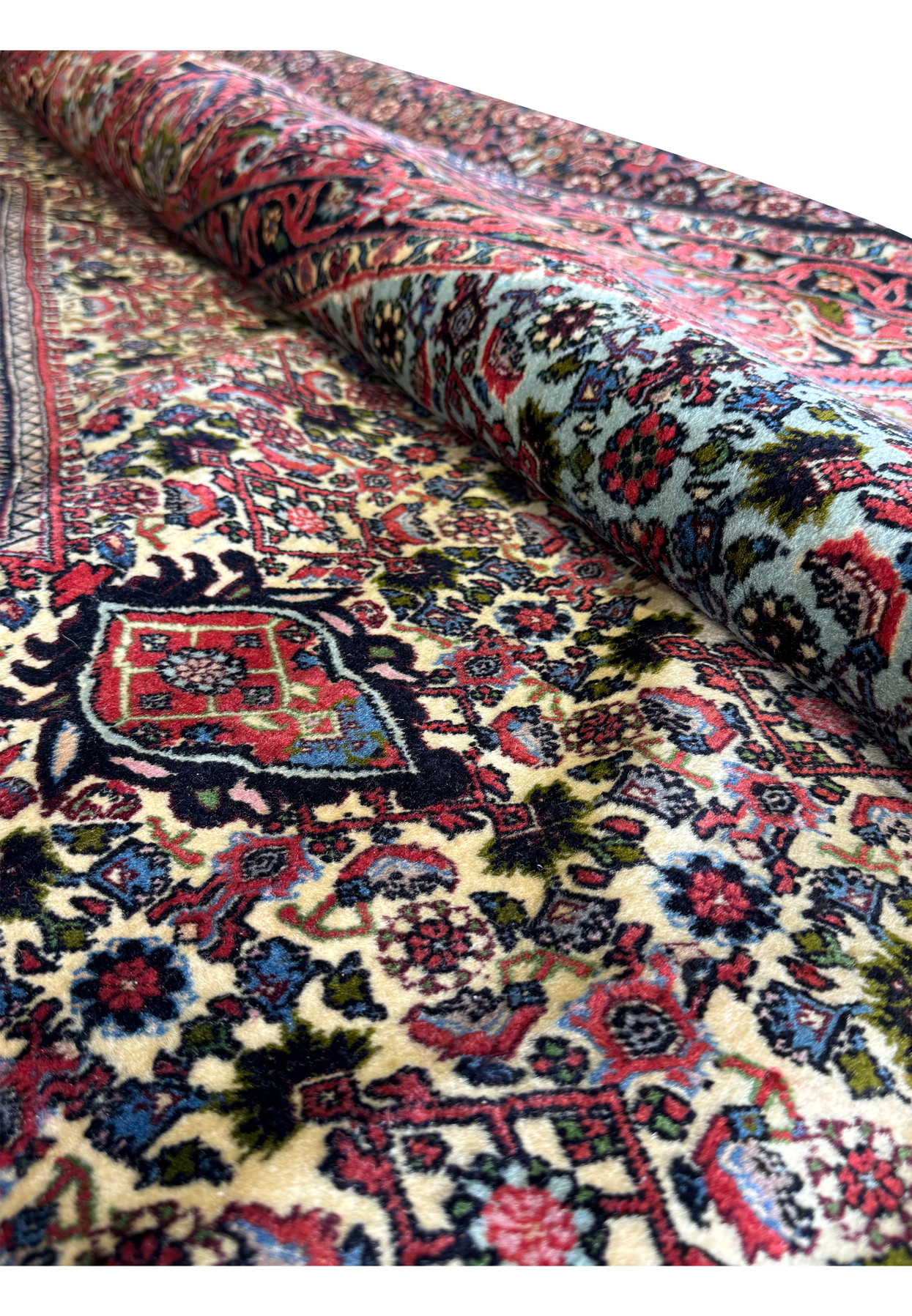 Rolled Persian Bijar Rug displaying the dense weave and vibrant patterns.