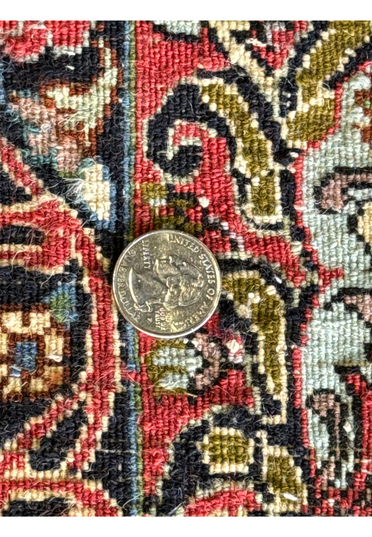 Zoomed into the back of the 9x12 Bijar Rug with a coin on the backside to show the high density of the weave.