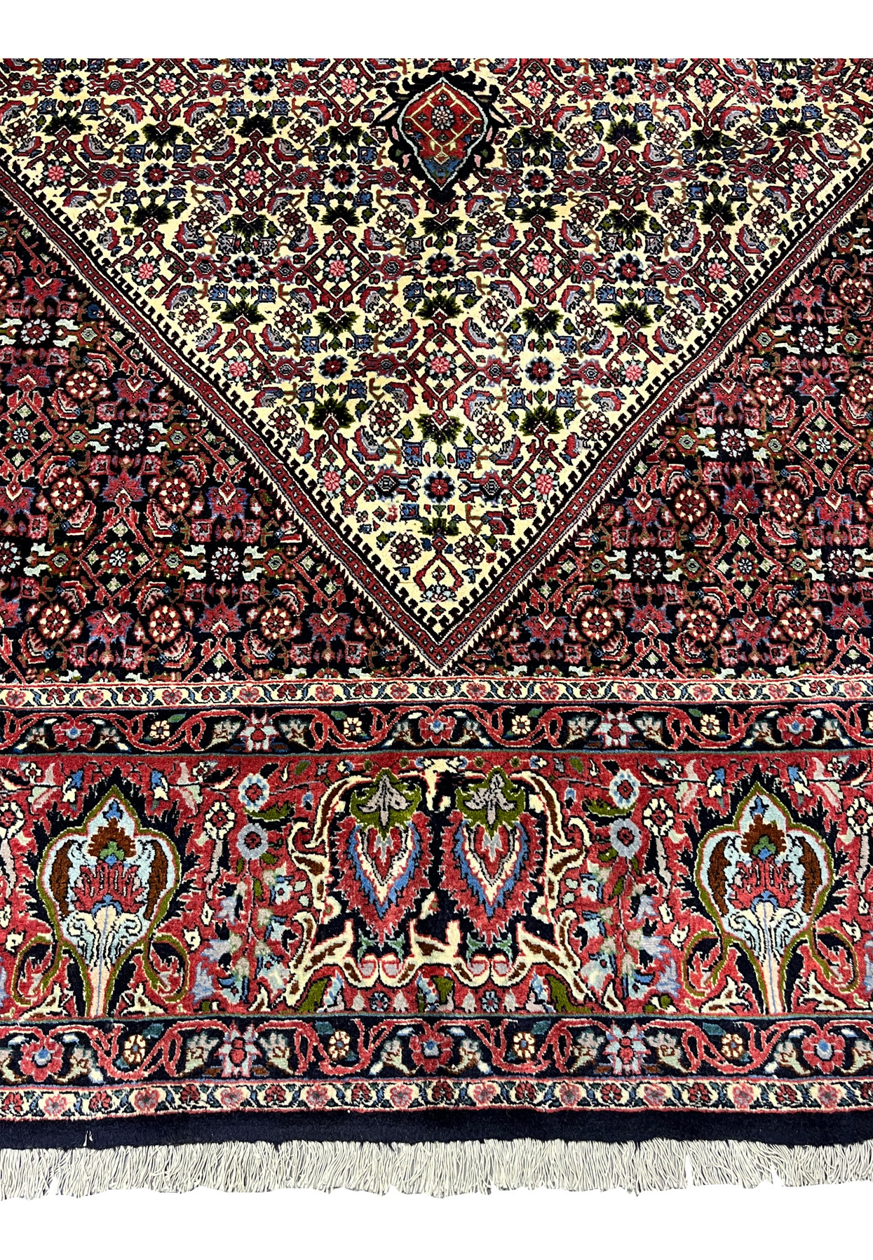Lower border detail of a 9.8 x 12.2 Persian Bijar rug featuring bold floral motifs, deep red and navy accents, and tightly packed knots typical of Bijar weaving.