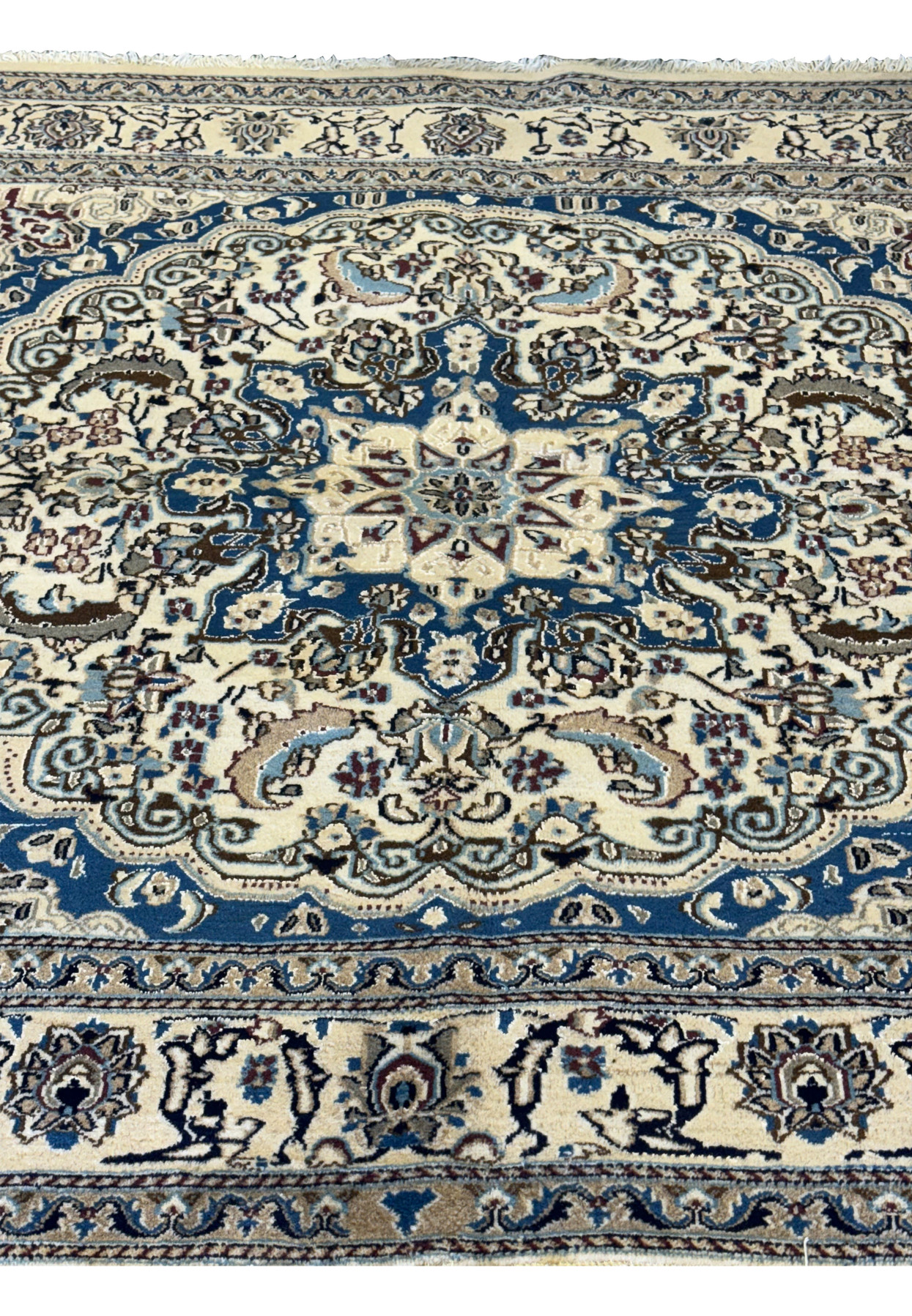 Close-up of the floral motifs and border details on the Persian Nain Square Rug.