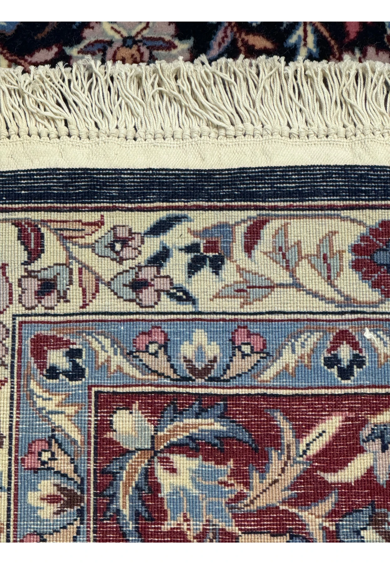 Close-up of the back of an 6'2 x 9'6 Persian Isfahan Rug showcasing intricate craftsmanship and detailed weaving