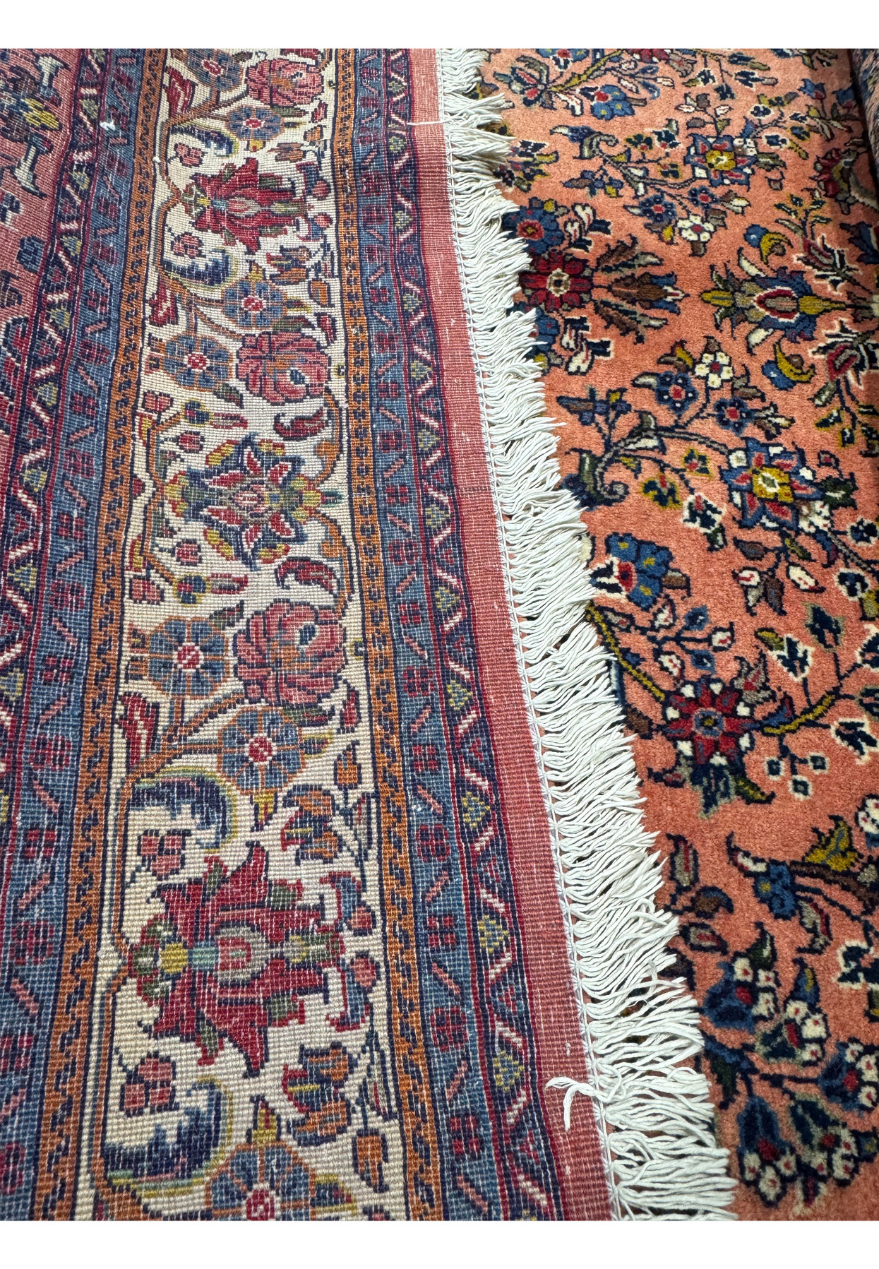 Close-up view of the back weave of the 5'6" x 8'5" Persian Sarouk rug, showcasing the intricate knotting and detailed craftsmanship.