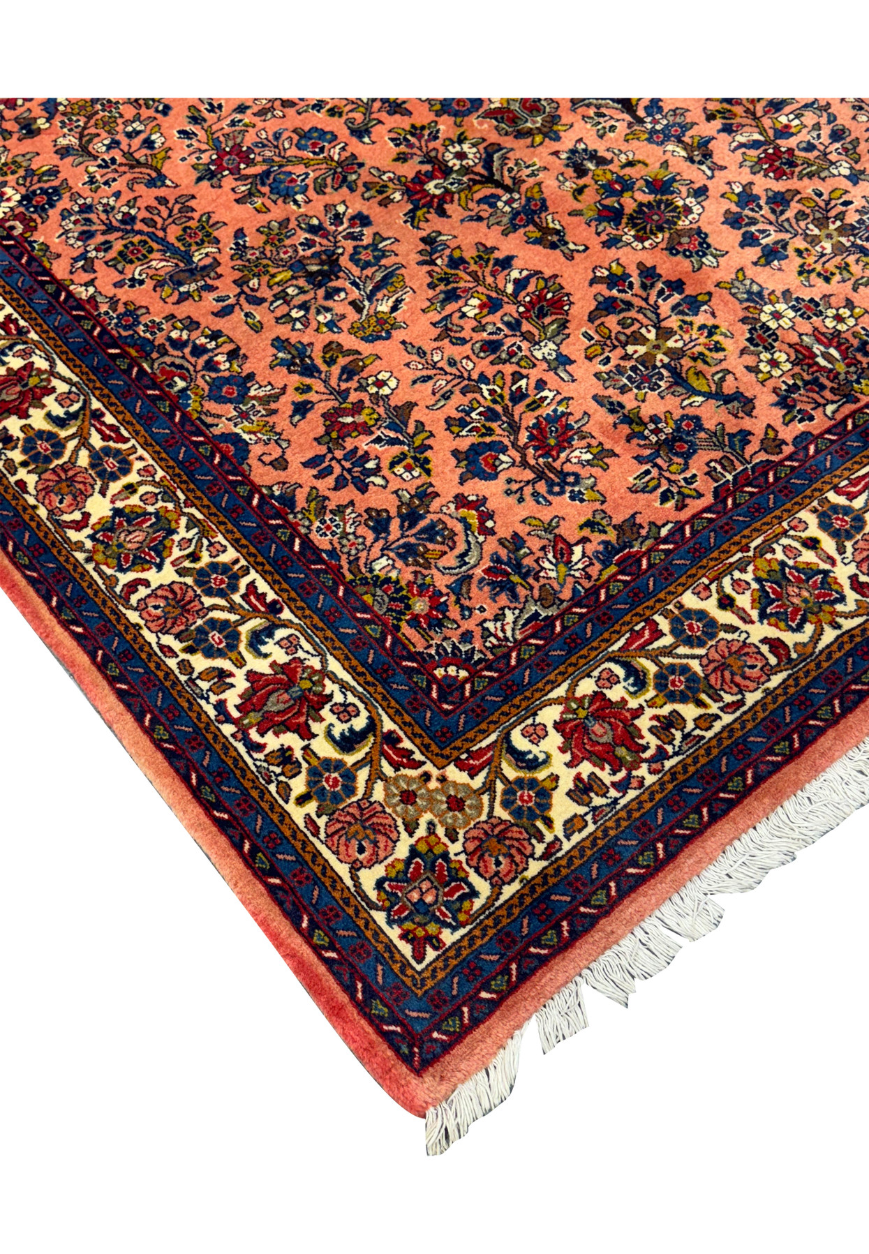 Corner detail of the 5'6" x 8'5" Persian Sarouk rug with fringe.