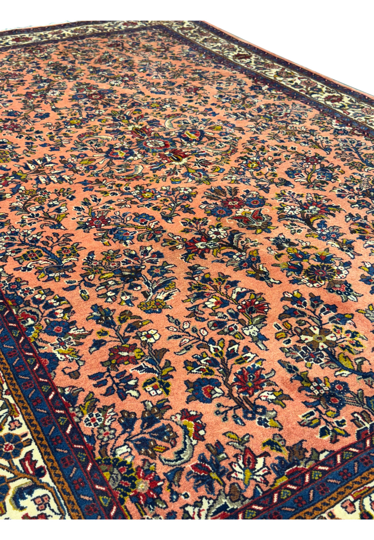 Angled view of the 5'6" x 8'5" Persian Sarouk rug showing the intricate design.