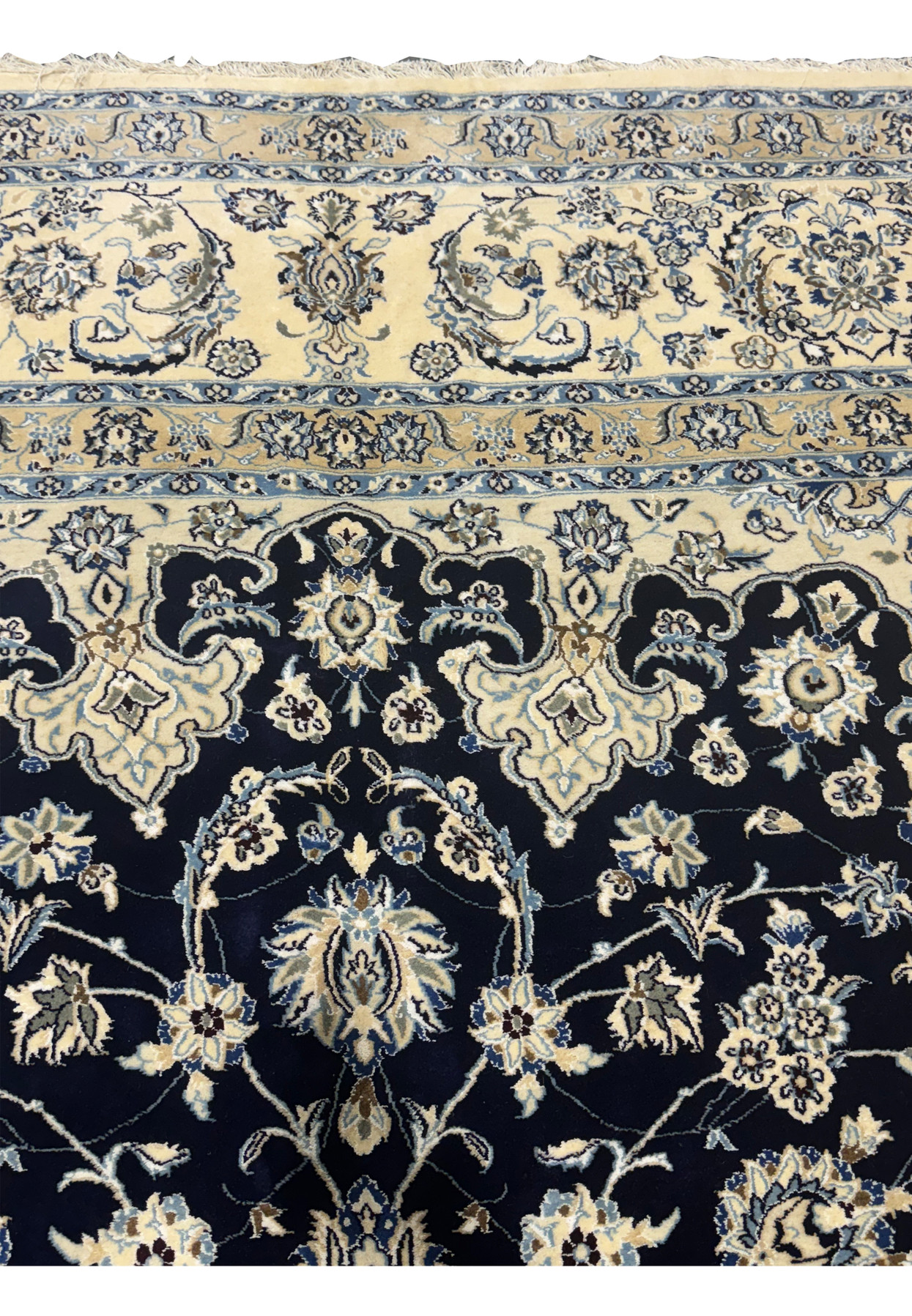 Upper border of this 13x19'8 Persian Nain 9LA Rug with dominantly ivory and navy blue colors