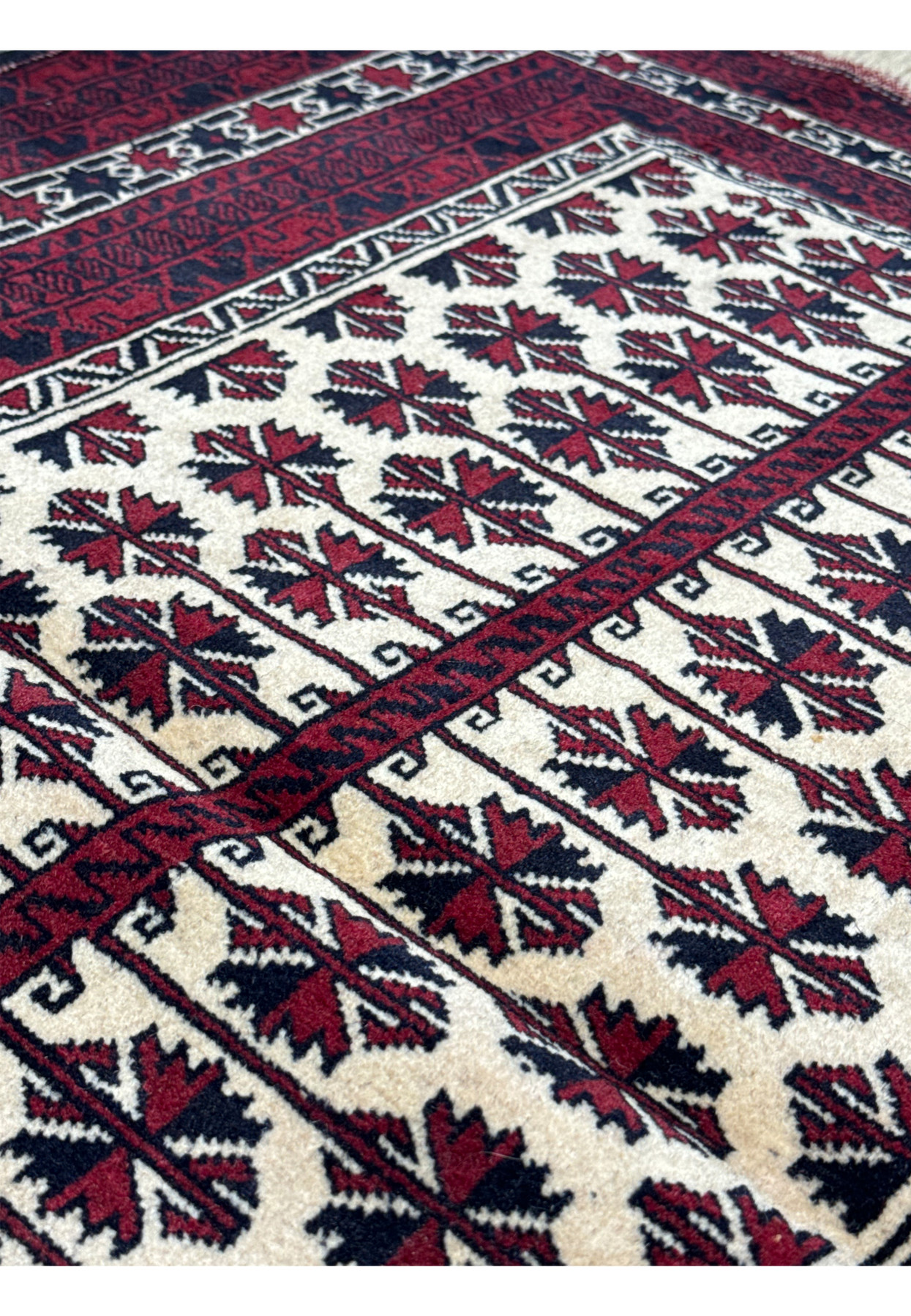 Close-up of the corner and fringe of a 3'1 x 4'2 Persian Baluch rug, highlighting the fine hand-knotted details and traditional motifs