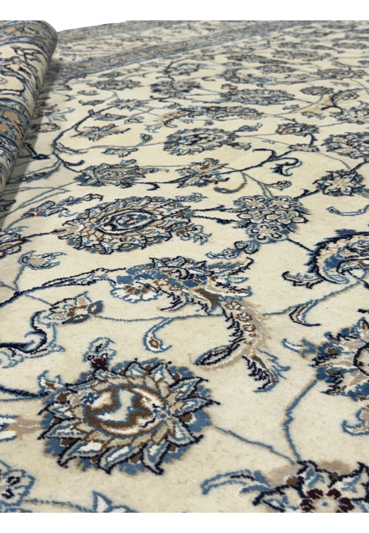 Detailed floral motifs on a Persian Nain 9LA Wool & Silk Rug with a close-up view