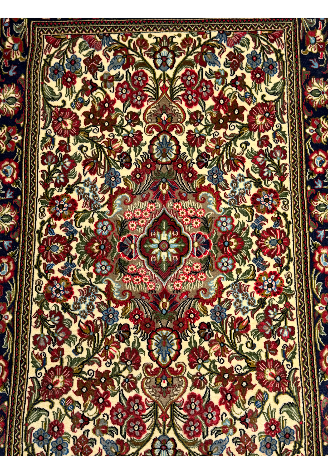 Close-up of the central floral motifs on a Persian Qum Kork rug