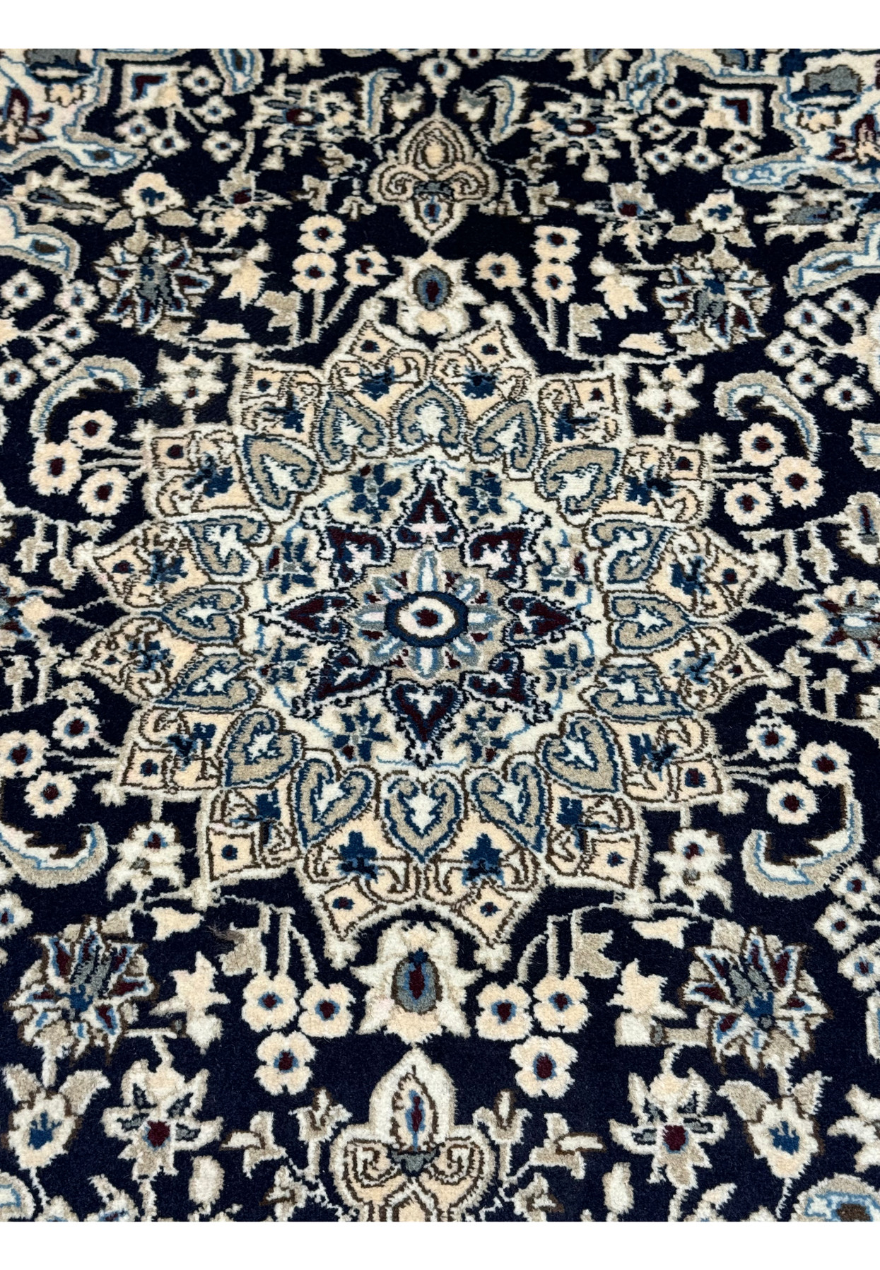 Close-up of the central medallion on the 3x5 Persian Nain rug.