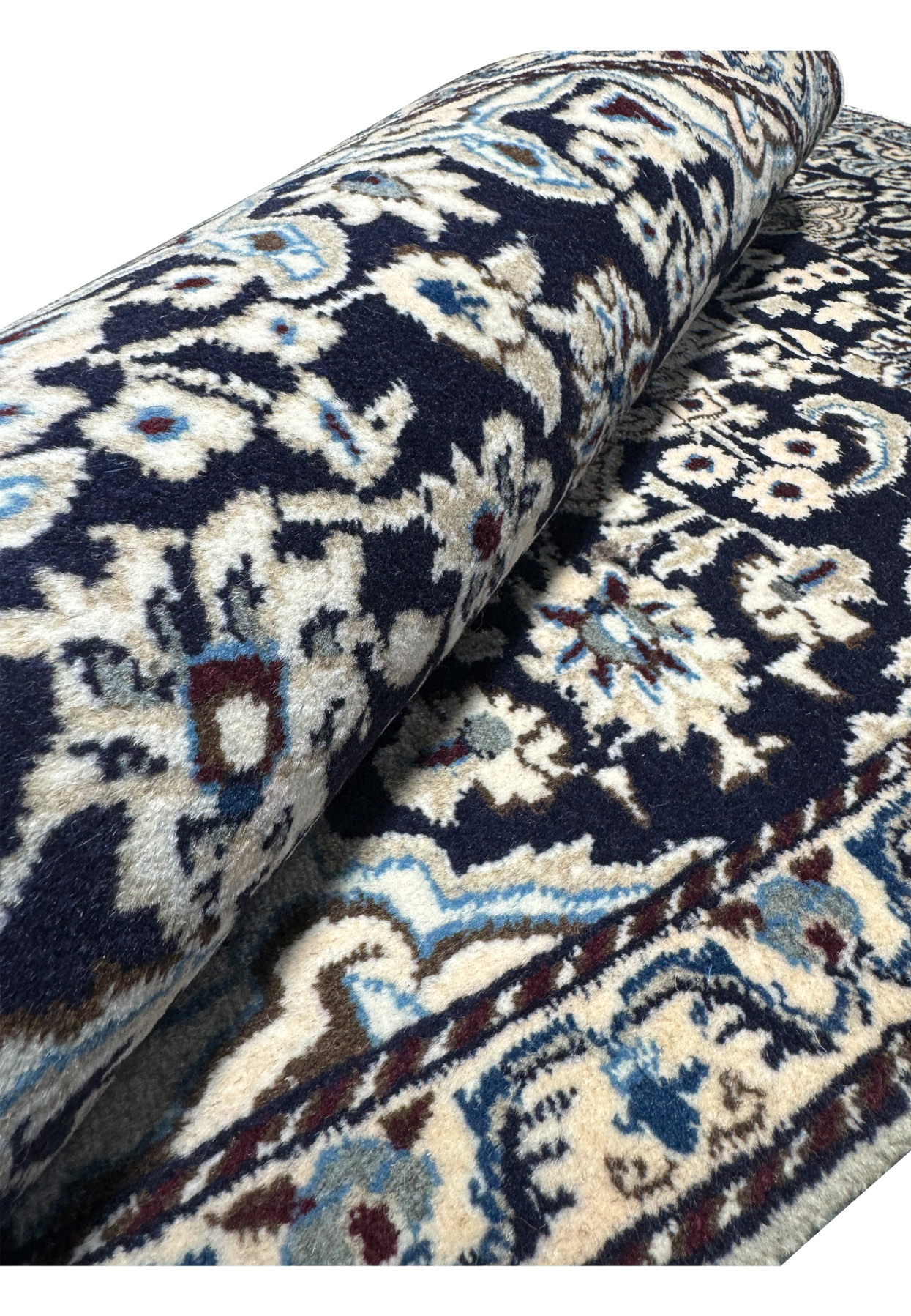 The 3x5 Persian Nain rug rolled up, showing its thickness and texture.