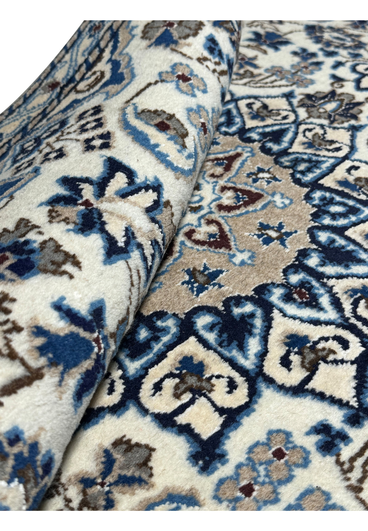 A close-up of the floral design on a 2'11 x 4'5 Persian Nain Rug, showcasing intricate patterns in blue and beige.