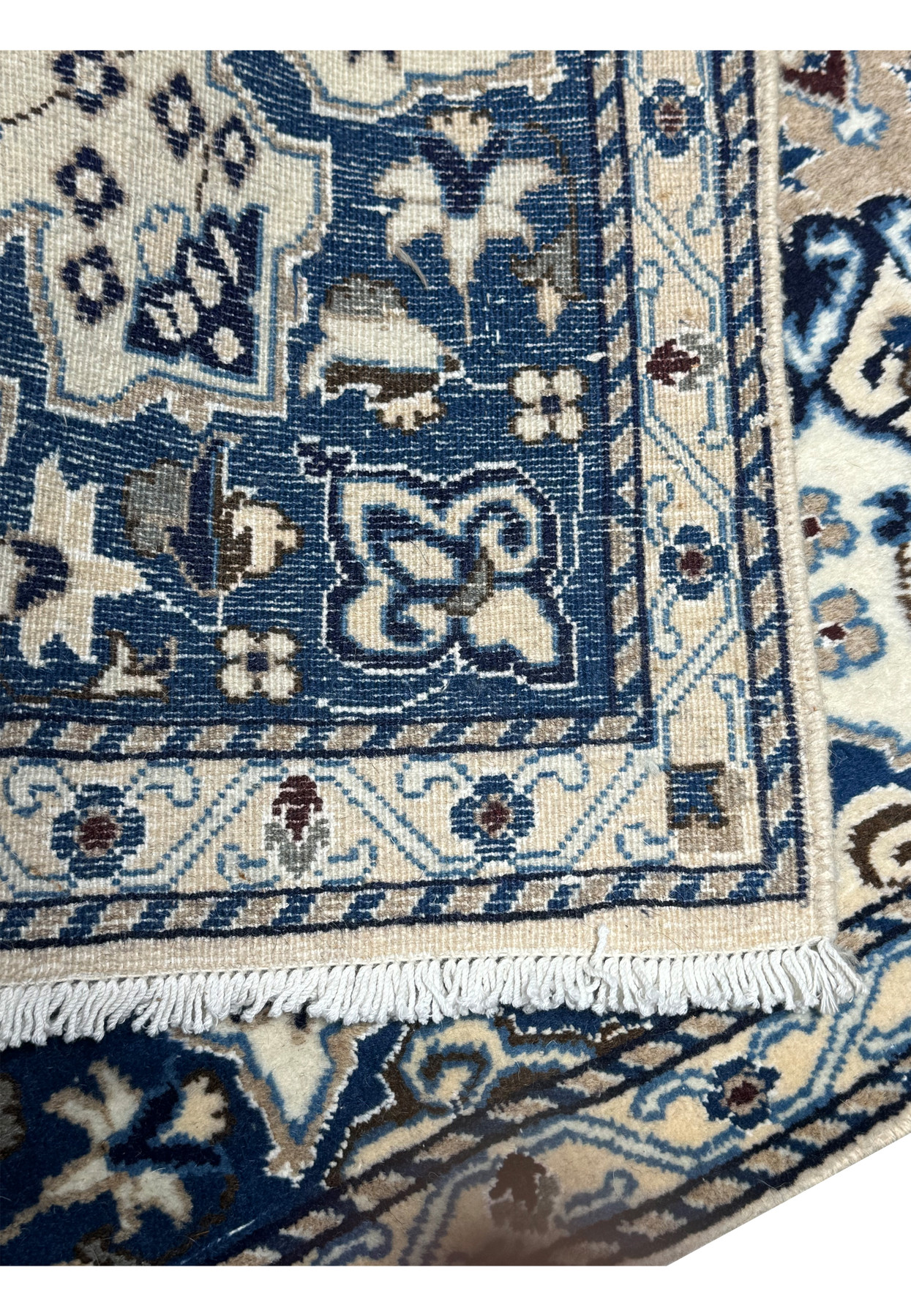 The backside of a 2'11 x 4'5 Persian Nain Rug, highlighting the precise knot work and craftsmanship.