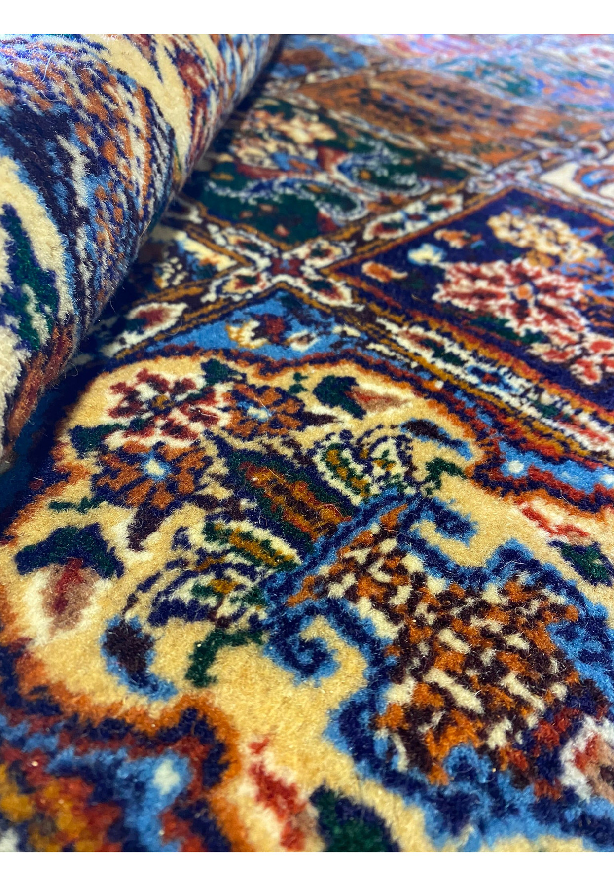 Close up of a 13x19 Rolled Moud Persian Rug panel design and colors.