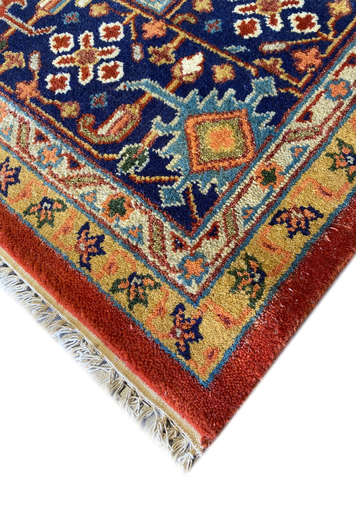Edge view  of the 12' x 15' Oriental Serapi Rug showcasing the vibrant colors.