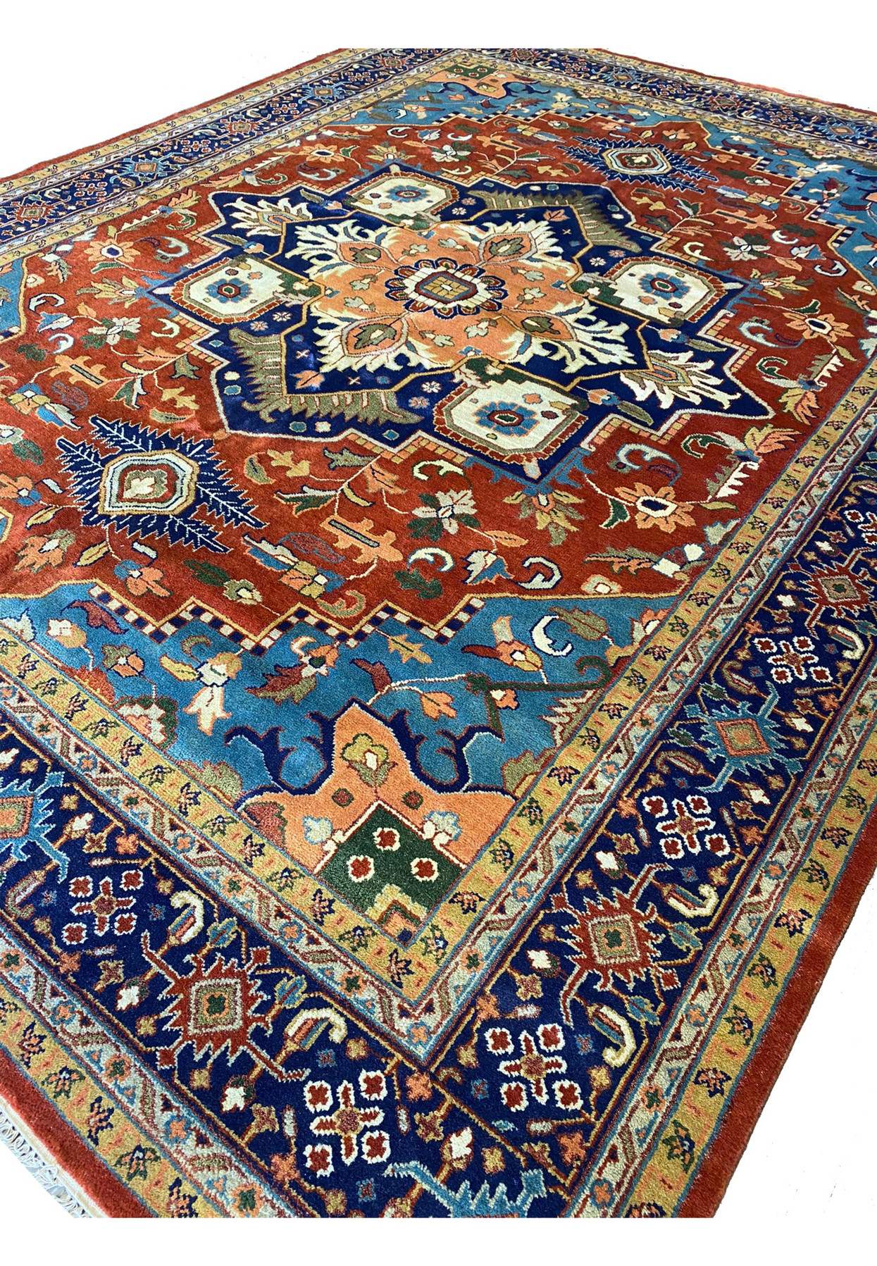 Angled view of the 12' x 15' Oriental Serapi Rug highlighting the rich red background.