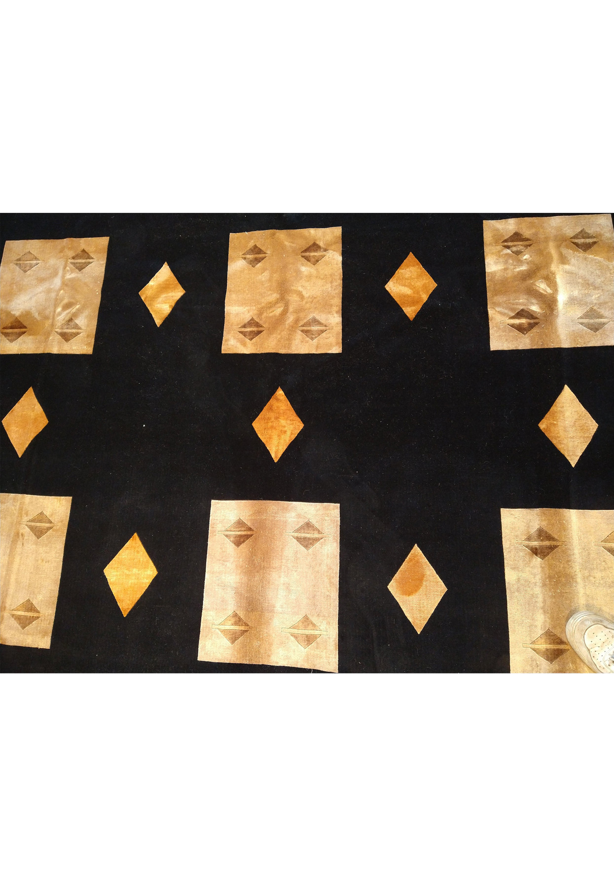 Pattern detail of 8'9 x 11'10 contemporary rug featuring golden geometric shapes.