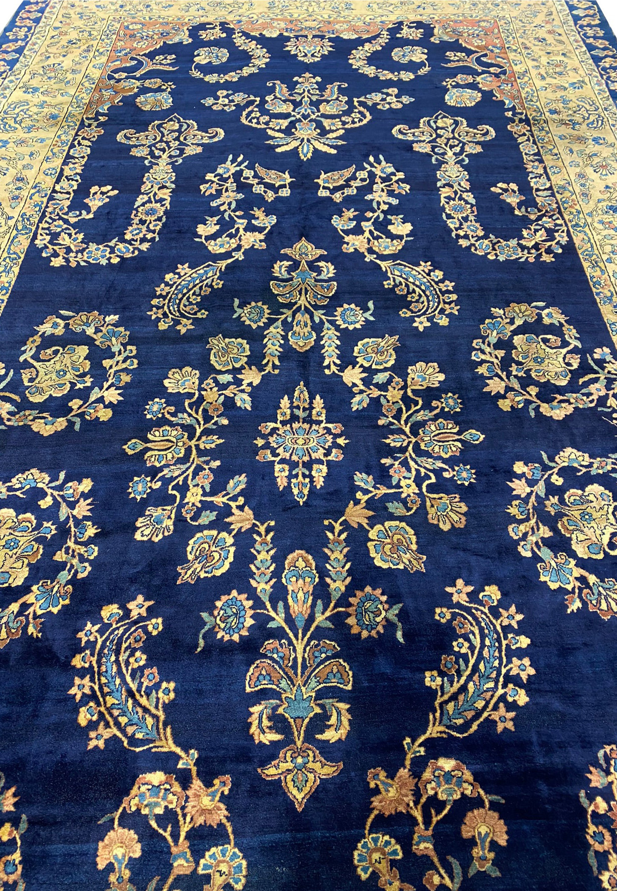 Close-up of floral patterns on the Persian Kerman Lavar rug, highlighting color details