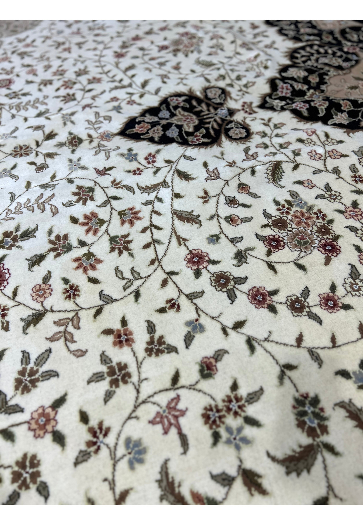 Intricate patterns of a 12'5" x 18' Persian Tabriz Rug, featuring classic motifs that enhance its historic allure.