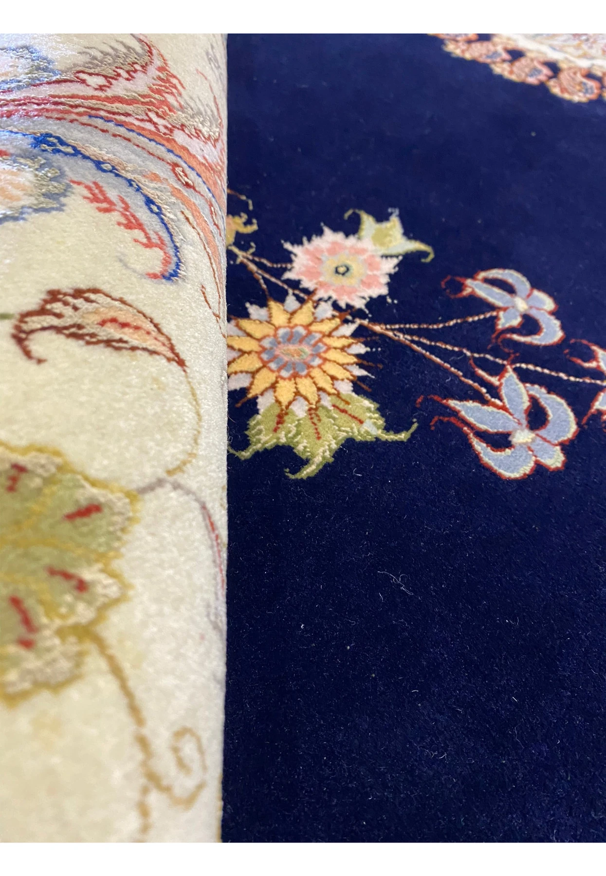Rolled view of the 10x13 Persian Tabriz Silk rug highlighting the rug's texture and pattern continuity.
