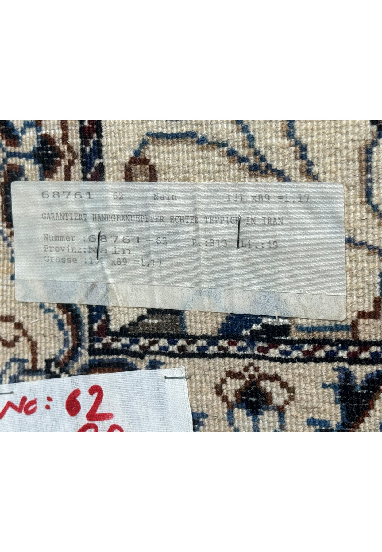 Tag on the backside of 3 x 4'4 Persian Nain Rug indicating its authenticity and origin.