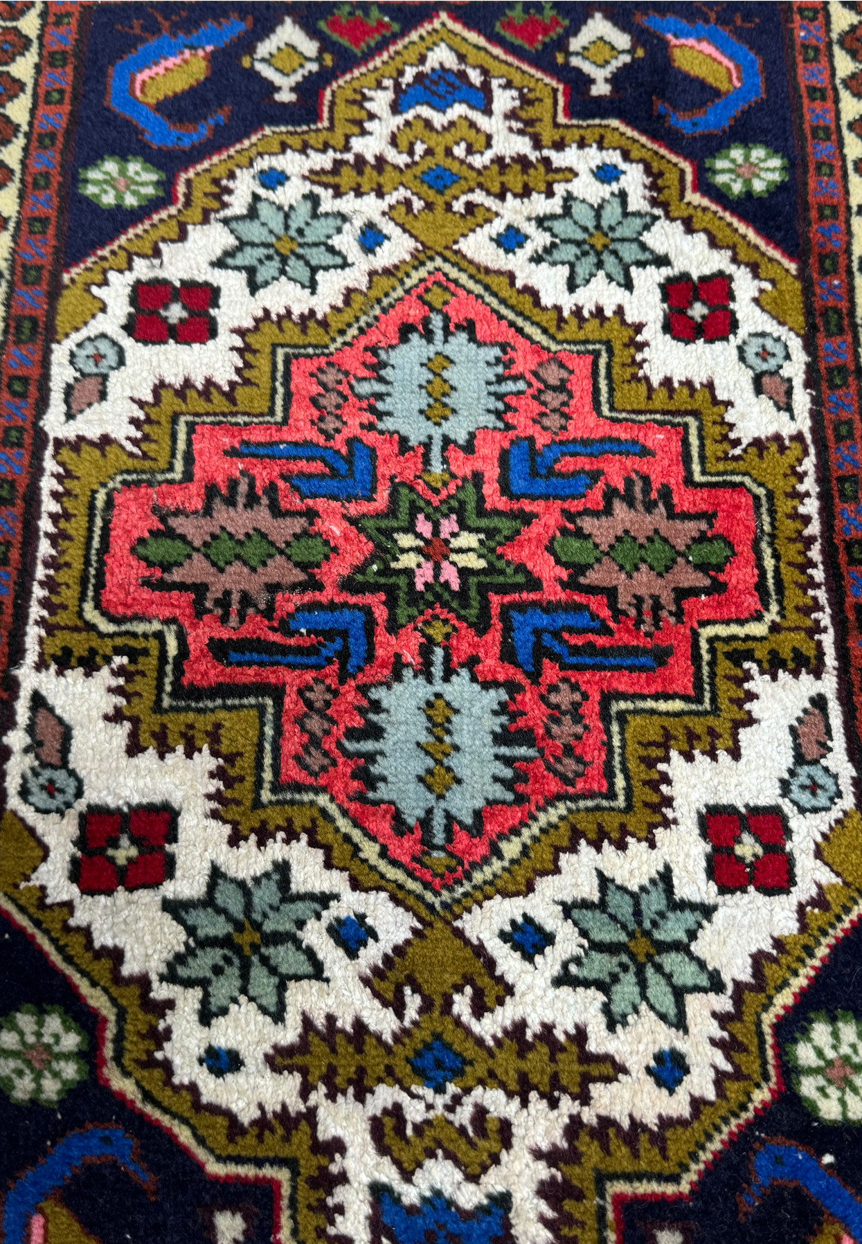Close-up of the central medallion on the 1'3 x 2' Persian Ardebil Baby Rug highlighting the colorful geometric design.
