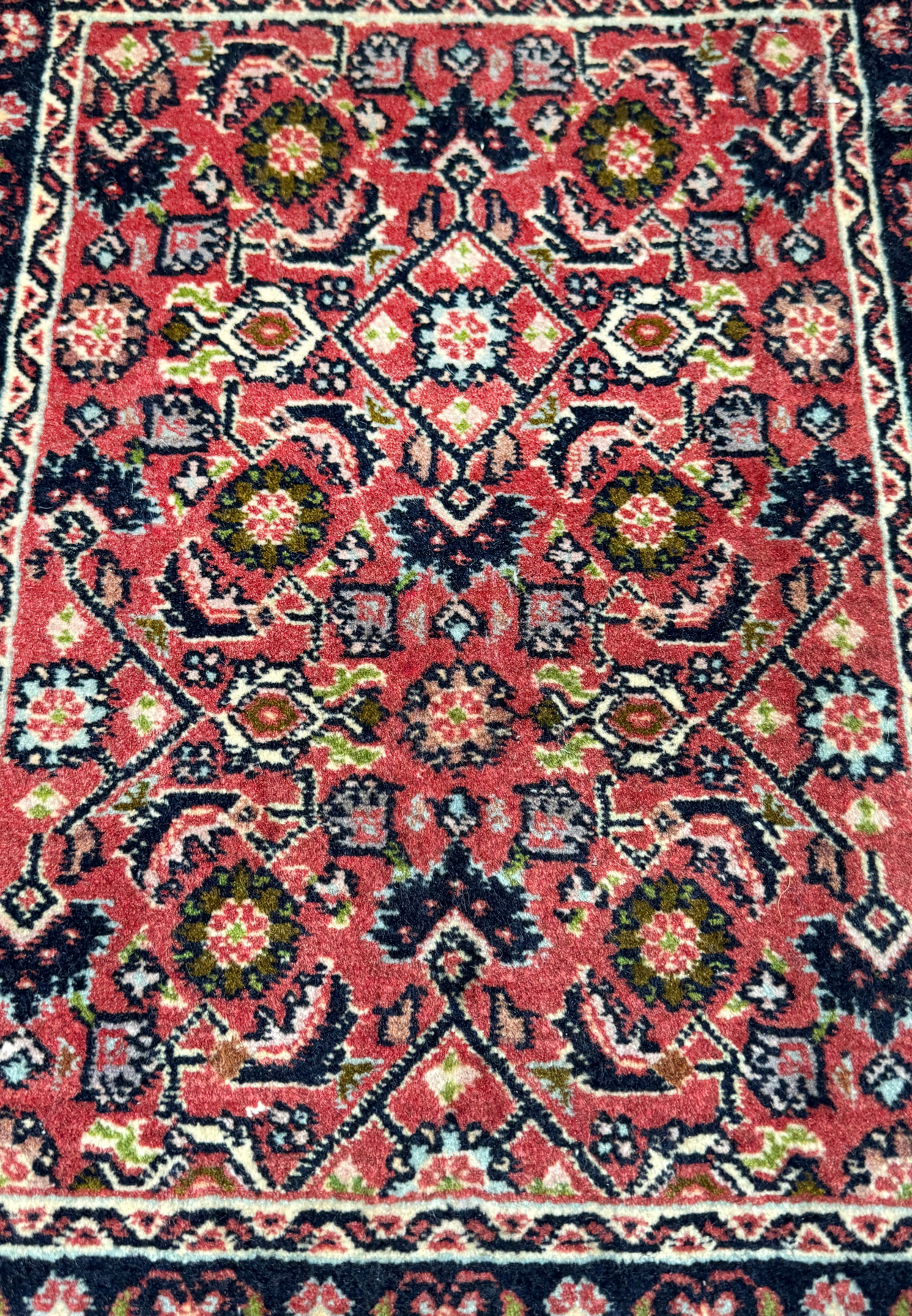 Close-up of the midfield design of a 1'3 x 2' Persian Baby Bijar Rug showcasing floral motifs and geometric shapes.