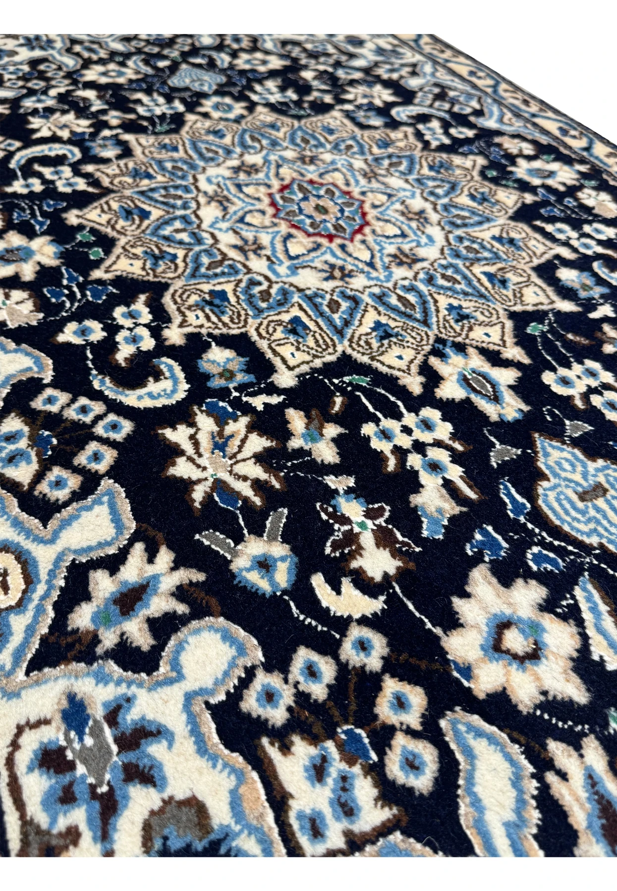 Angled view of a 2'8 x 4'6 Persian Nain Rug highlighting intricate wool weave and medallion design.