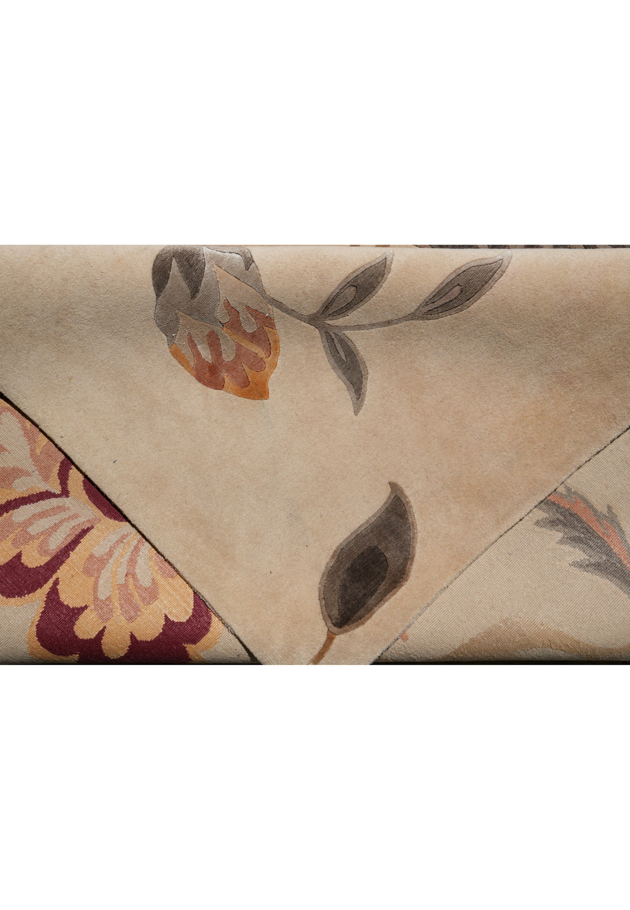 Close-up of edge on 9x12 Tibetan rug showing burgundy and gold flower
