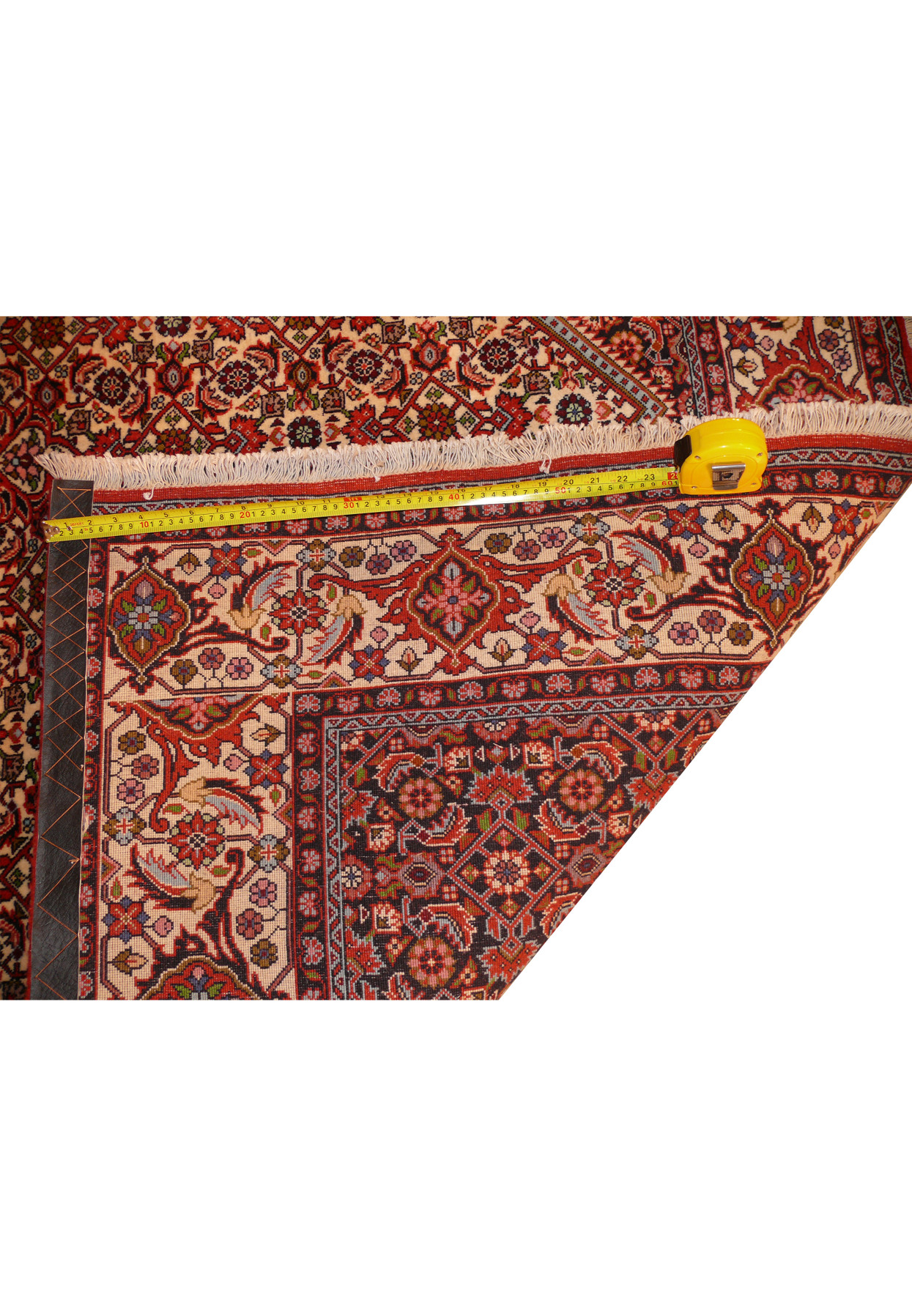 Corner fold revealing the rug's backside and fine hand-knotting technique.