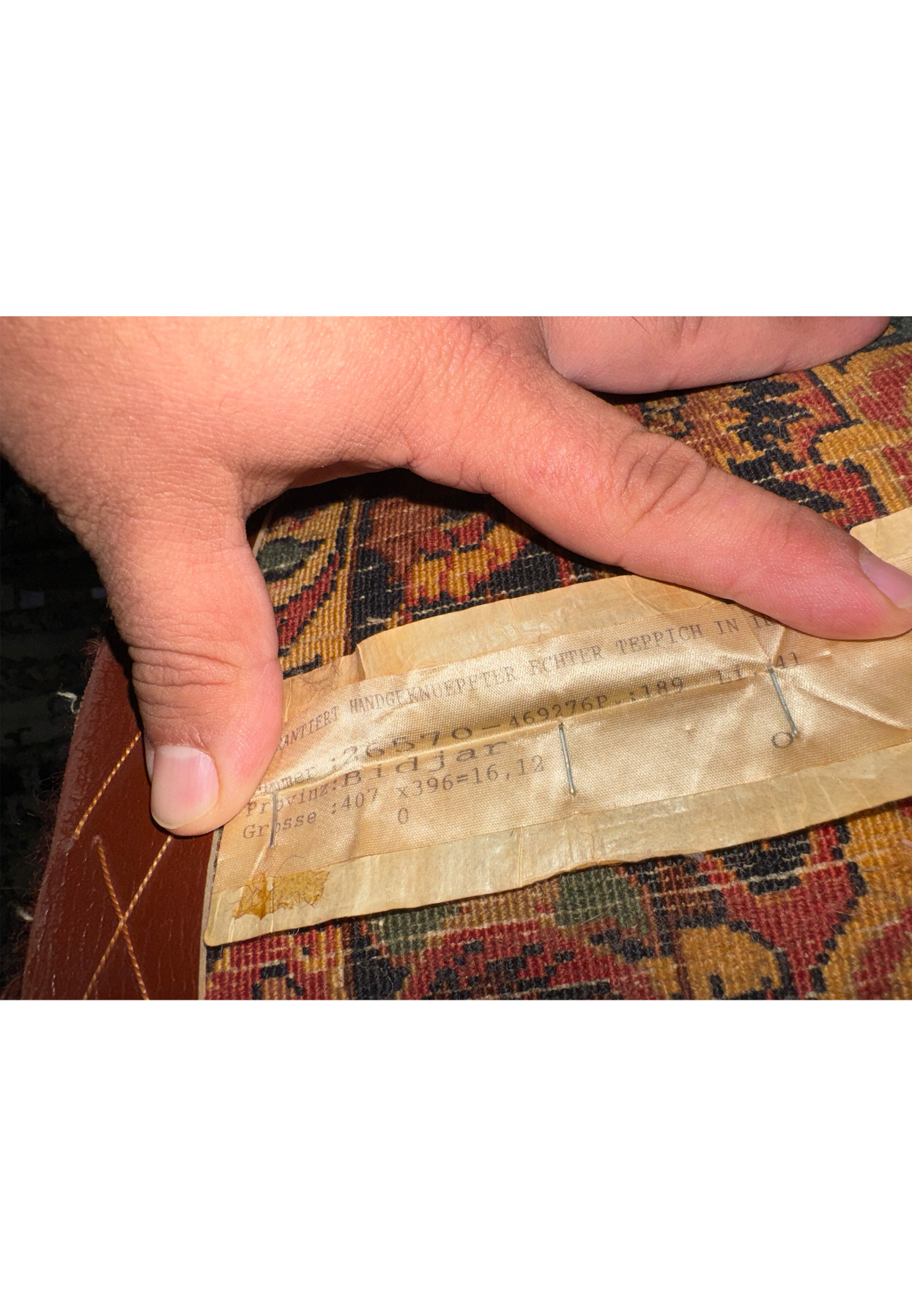 Back of antique Bijar rug with original European import label and wool foundation visible