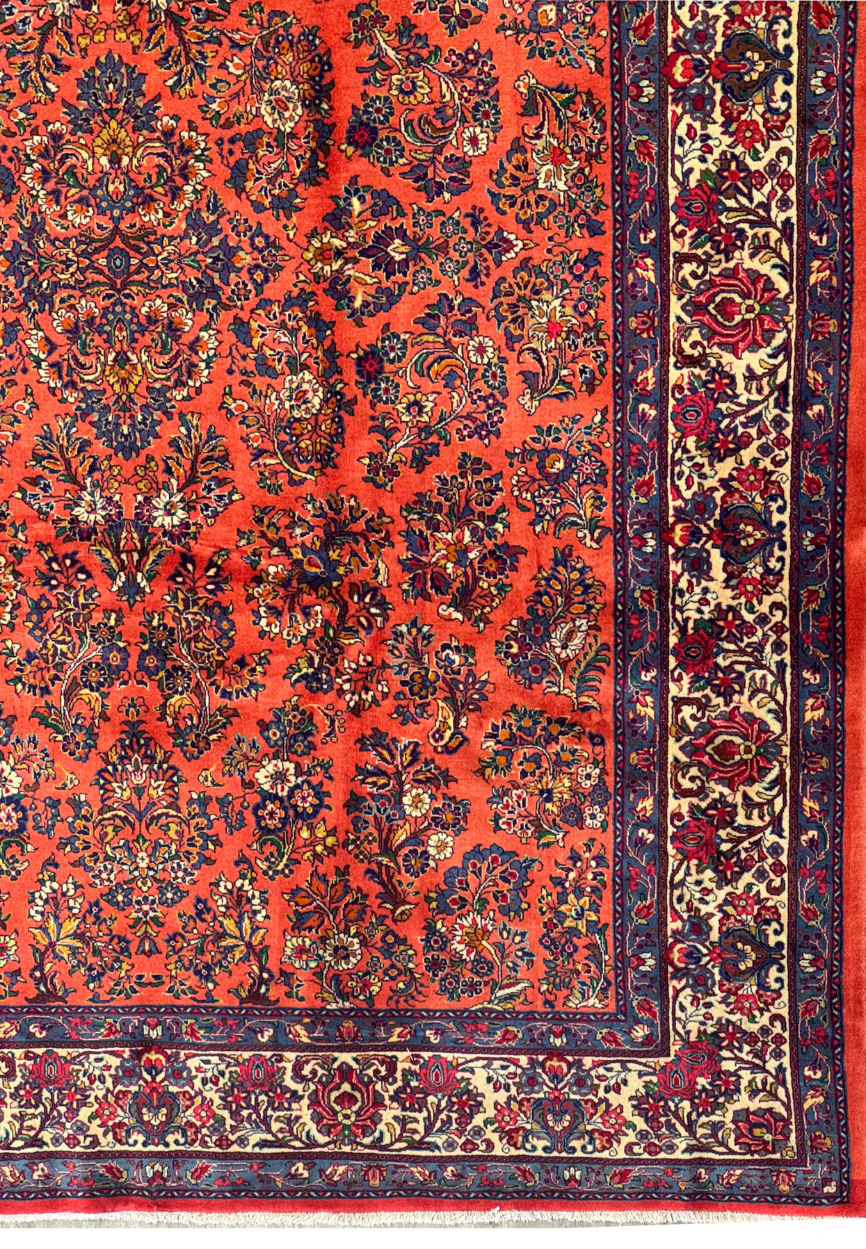 Persian Sarough rug border with ivory ground, navy and red floral sprays, framed by blue guard borders, hand-knotted wool craftsmanship.