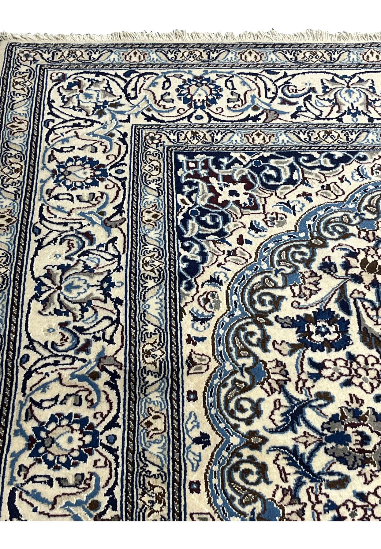 Upper edge view of Square Persian Nain Rug with ivory and navy border pattern
