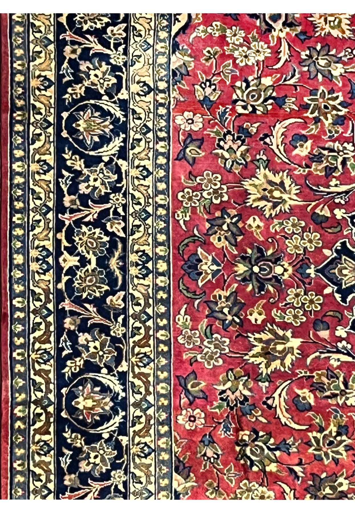 Side border detail featuring navy vines, beige flowers, and refined Isfahan craftsmanship.