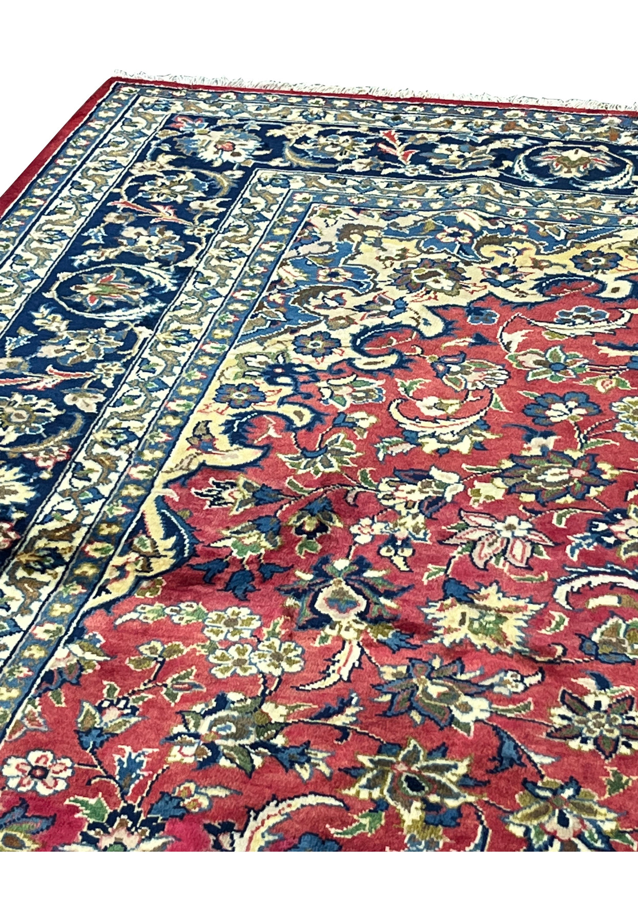 Upper edge of the rug showing navy guard borders, red field, and ivory accent florals.