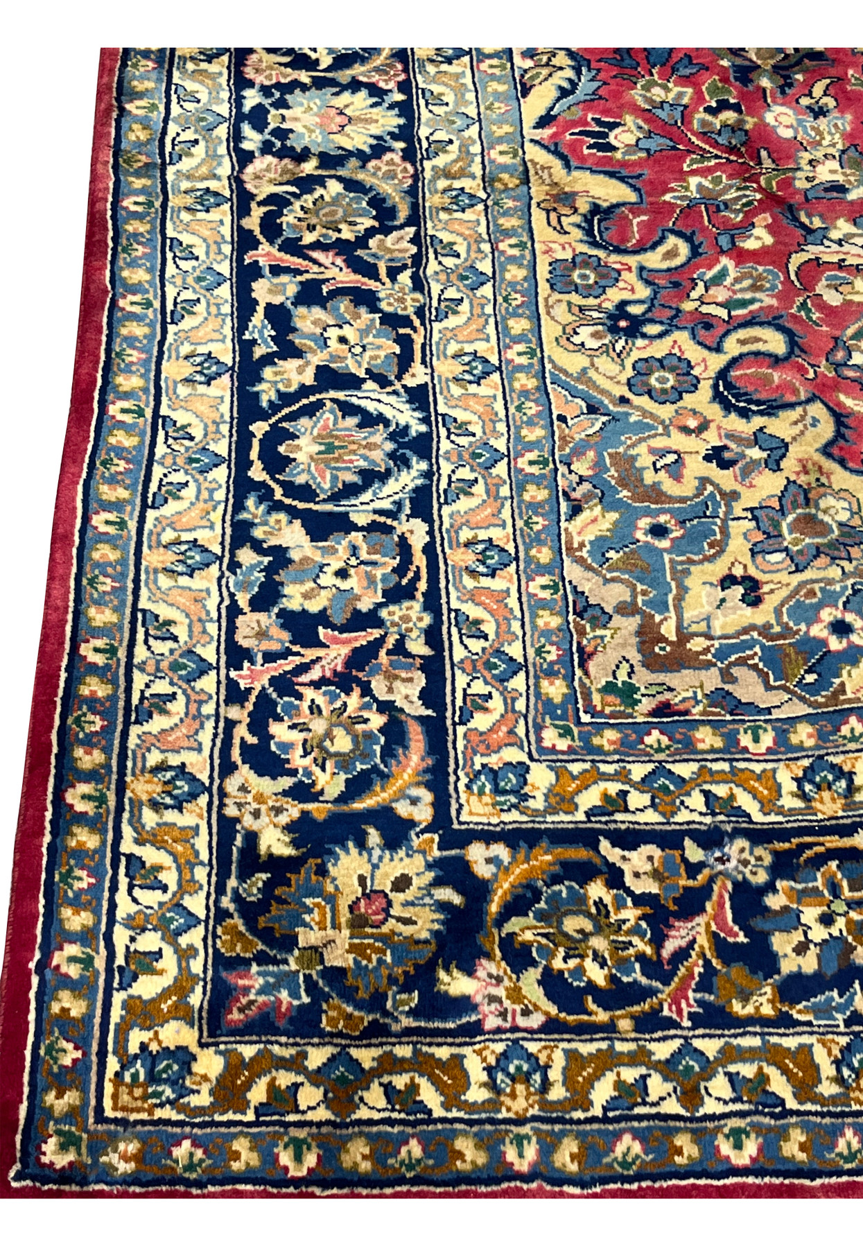 Lower edge of the 8'7 x 12'7 Distressed Persian Isfahan Rug showing intricate navy floral border, red fringe accents, and detailed Persian motifs in handwoven wool.