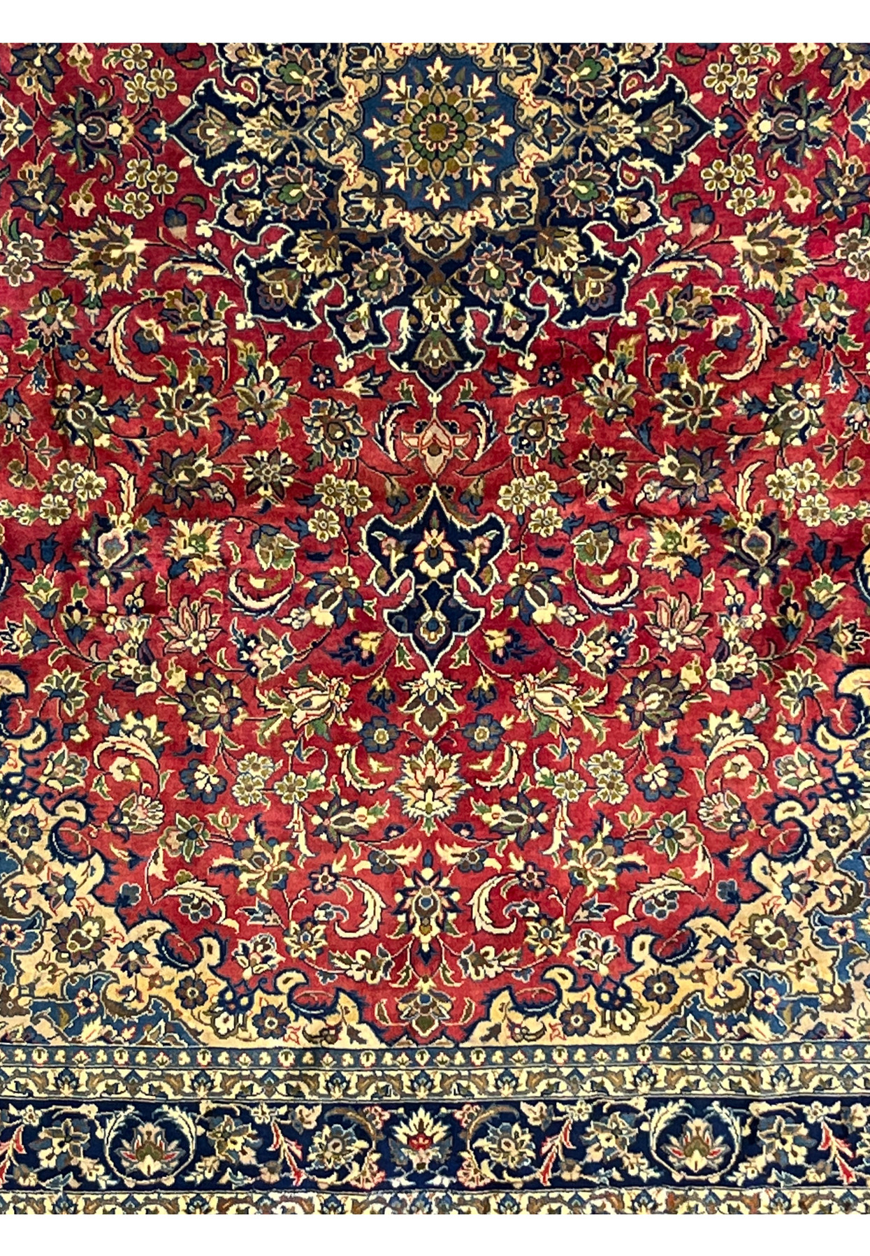 Lower part of the Isfahan Rug displaying navy and ivory floral borders and balanced medallion symmetry.