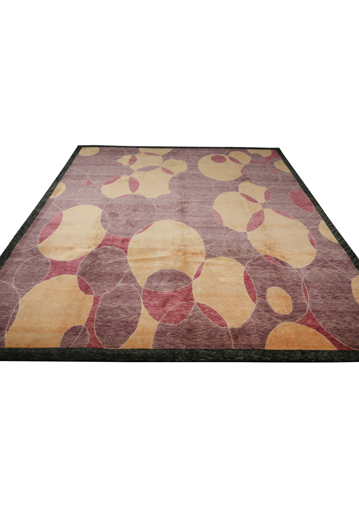 Laid-down image of the 8.2 x 10 Handmade Tibetan Rug displaying its even pile, rich color transitions from amber to plum, and meticulously carved circular design framed by a gray border.