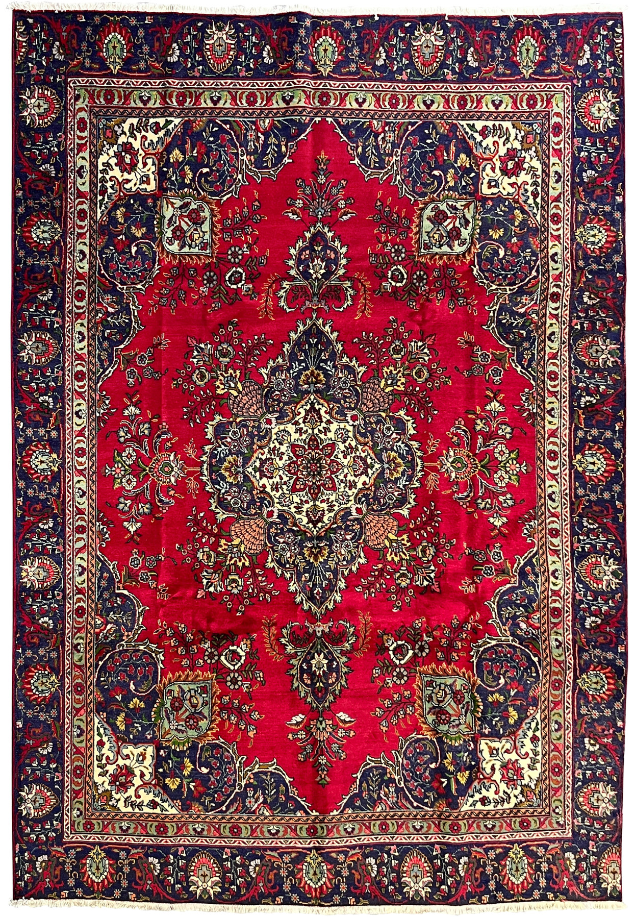 Full view of 8'5" x 12'9" Persian Tabriz wool rug with red field, ivory medallion, and navy blue borders