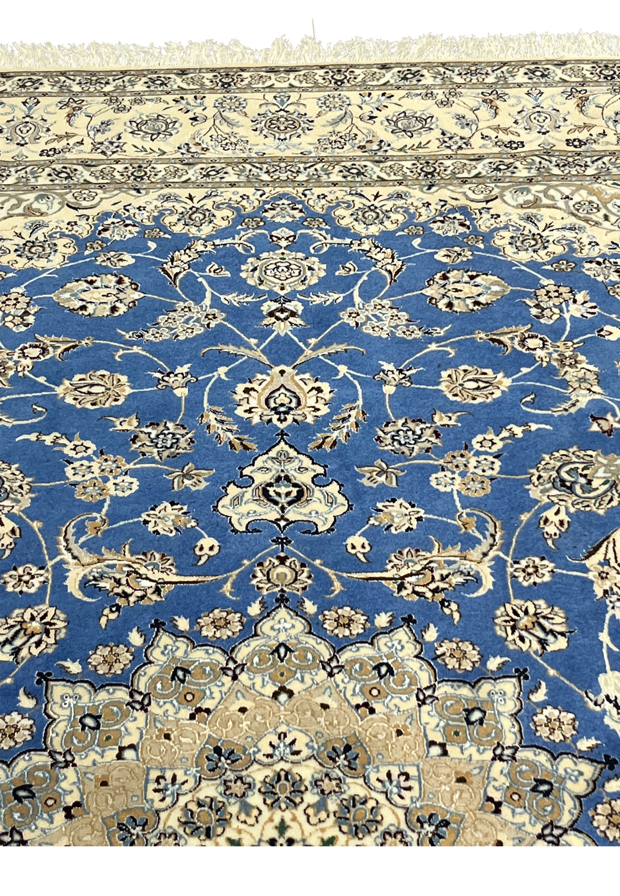 Upper border of Persian Nain rug highlighting ivory background and floral scroll pattern