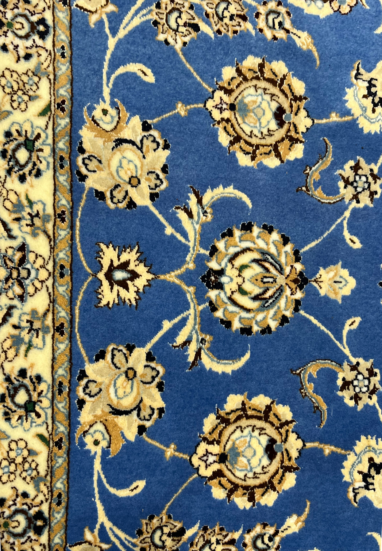 Detailed floral and vine motifs of Persian Nain rug with blue, beige, and ivory tones
