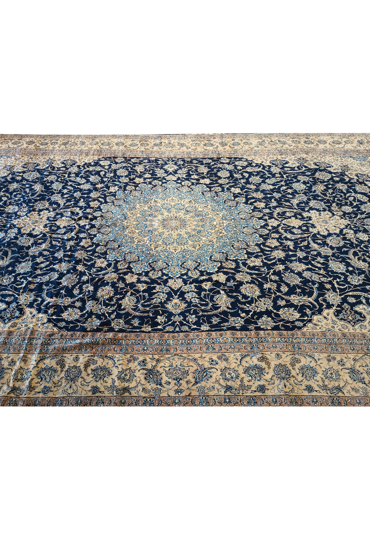 14x25'6 Nain 9 LA Persian rug laid flat with fold lines on navy and ivory floral pattern.