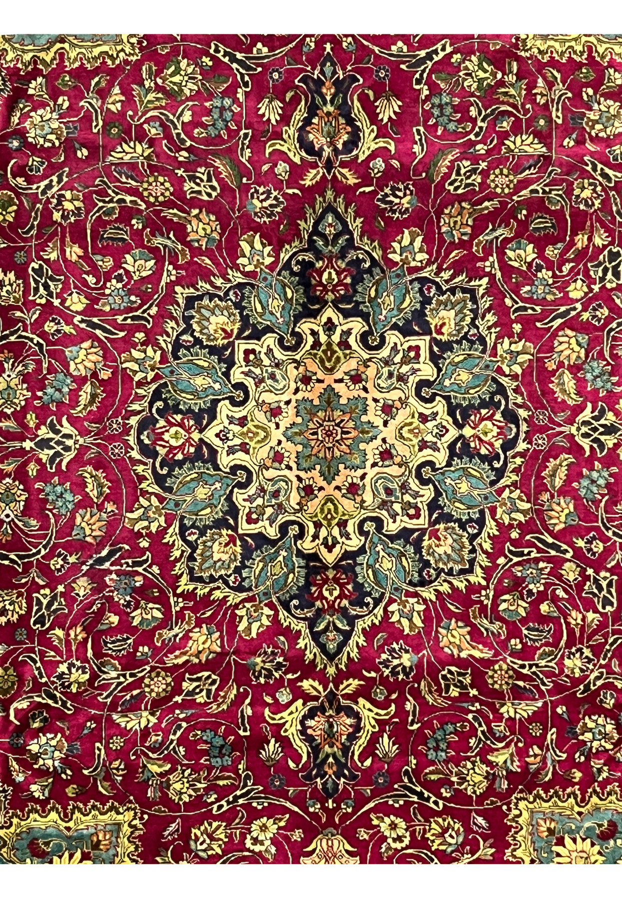 edge and fringe detail of Persian Tabriz rug with navy floral border and red outer band